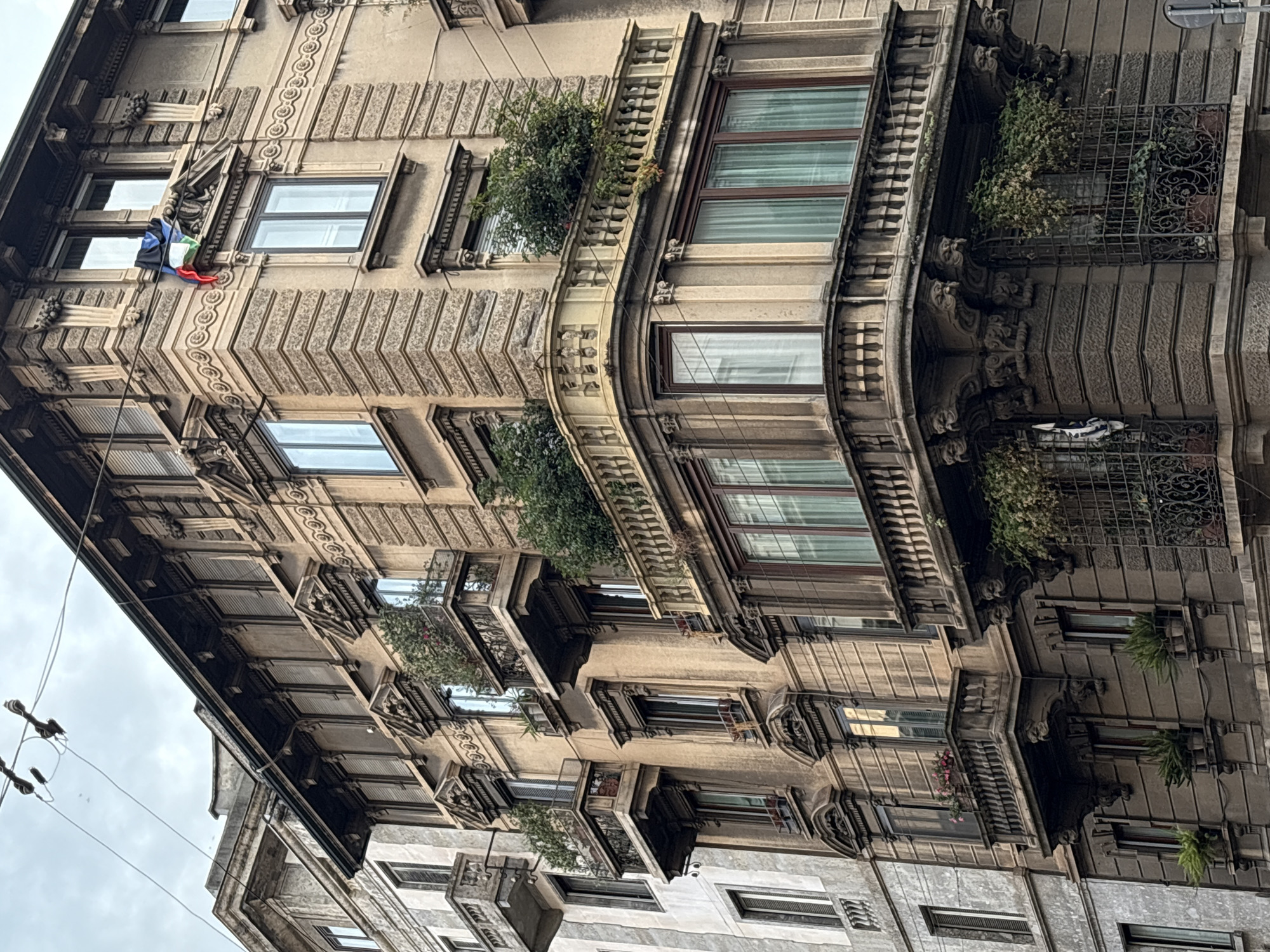 Witness documents Milan architectural facades during evening walk