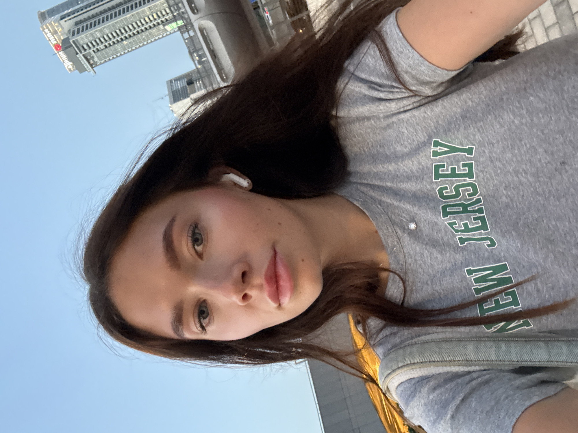 Woman takes selfie with earbud in Tel Aviv