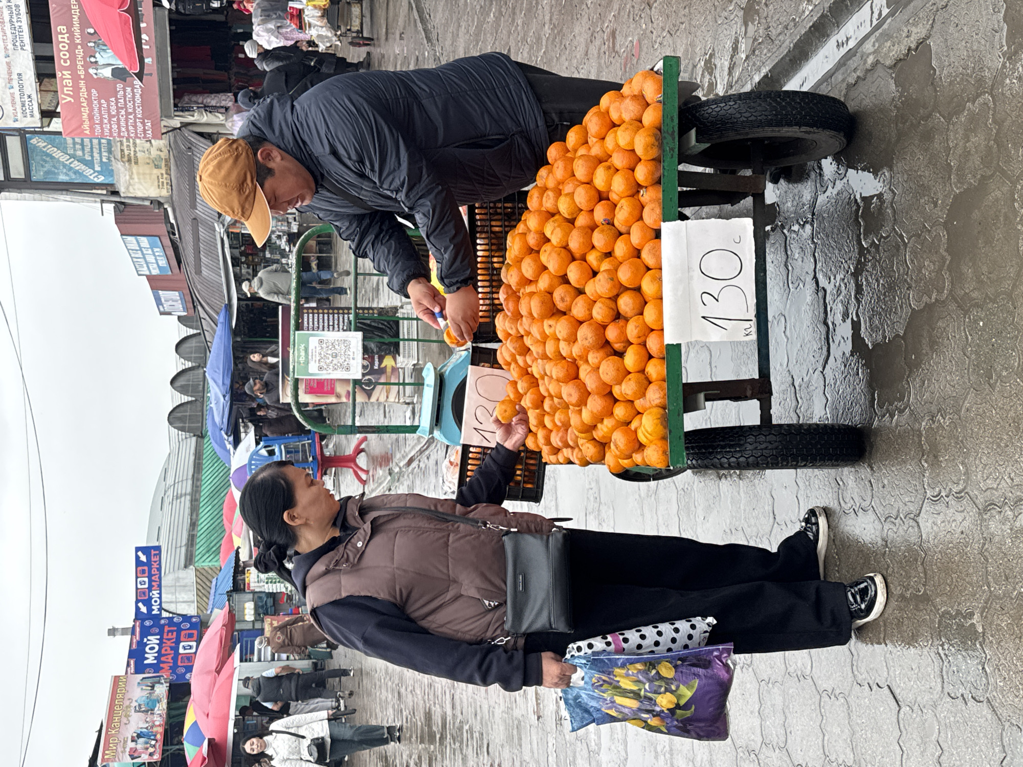 Morning market activity documented in rainy Bishkek