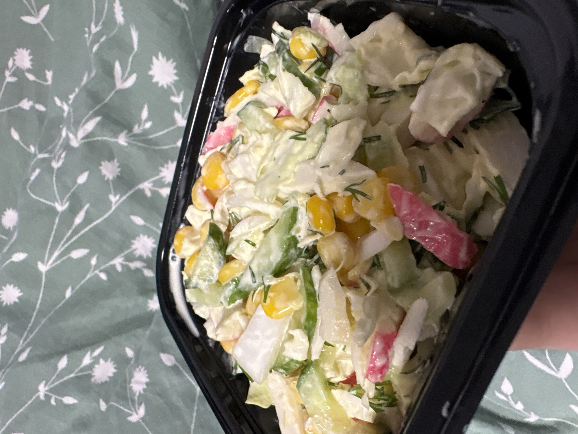 Prepared salad with vegetables and crab meat photographed in Russia