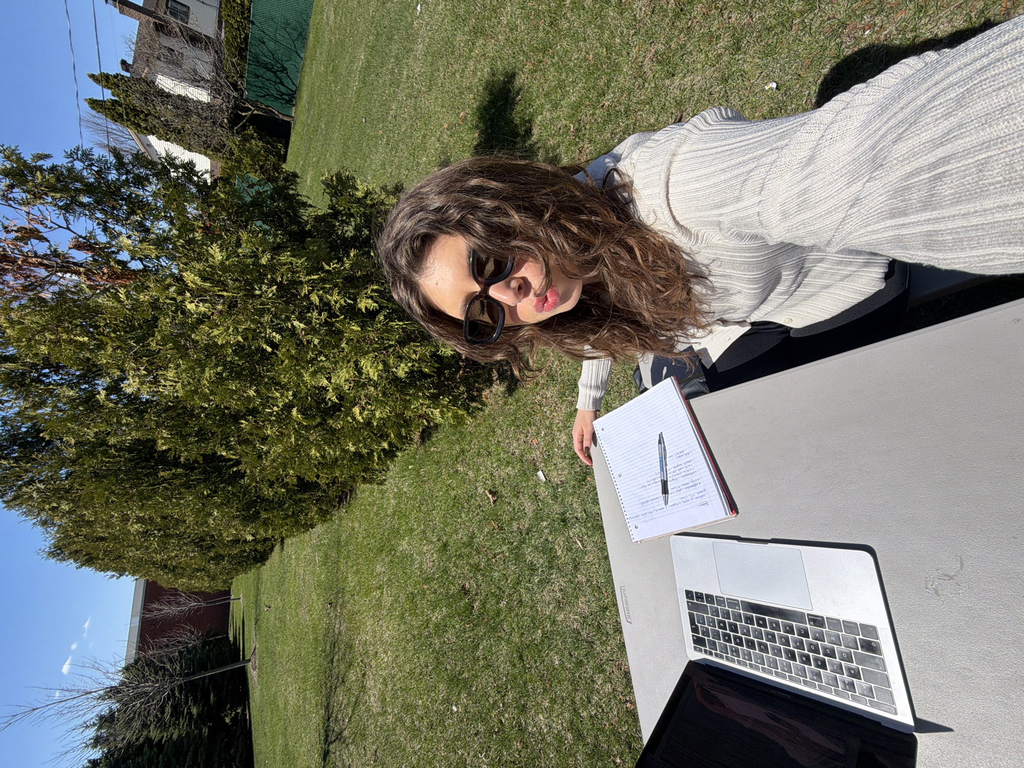 Woman sits at outdoor table in Longueuil