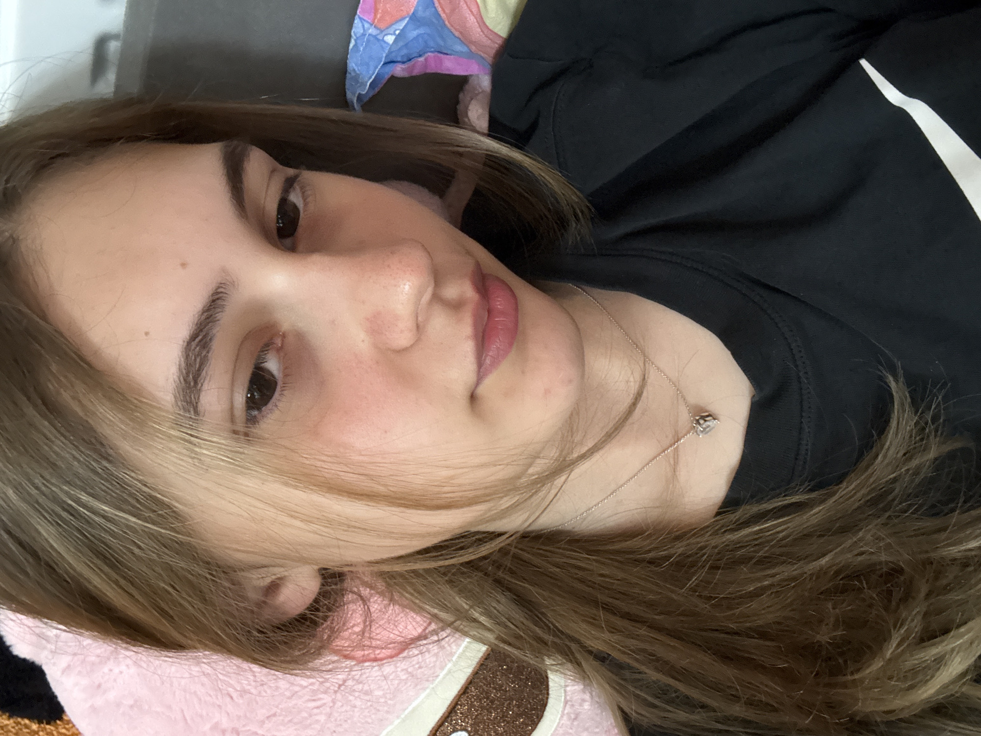 Young woman takes playful selfies in Bulgarian bedroom