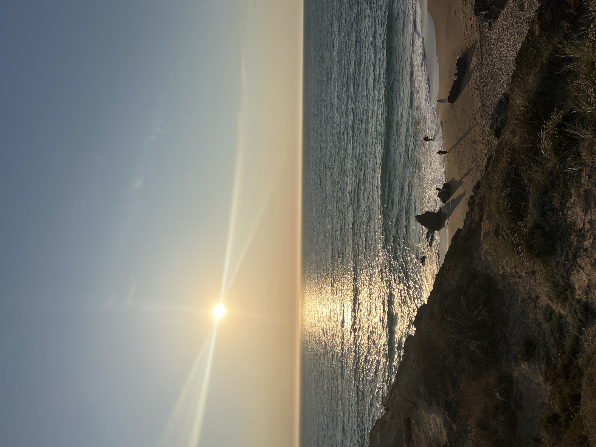 Sunset along the Cascais coast, cliffs and open beach