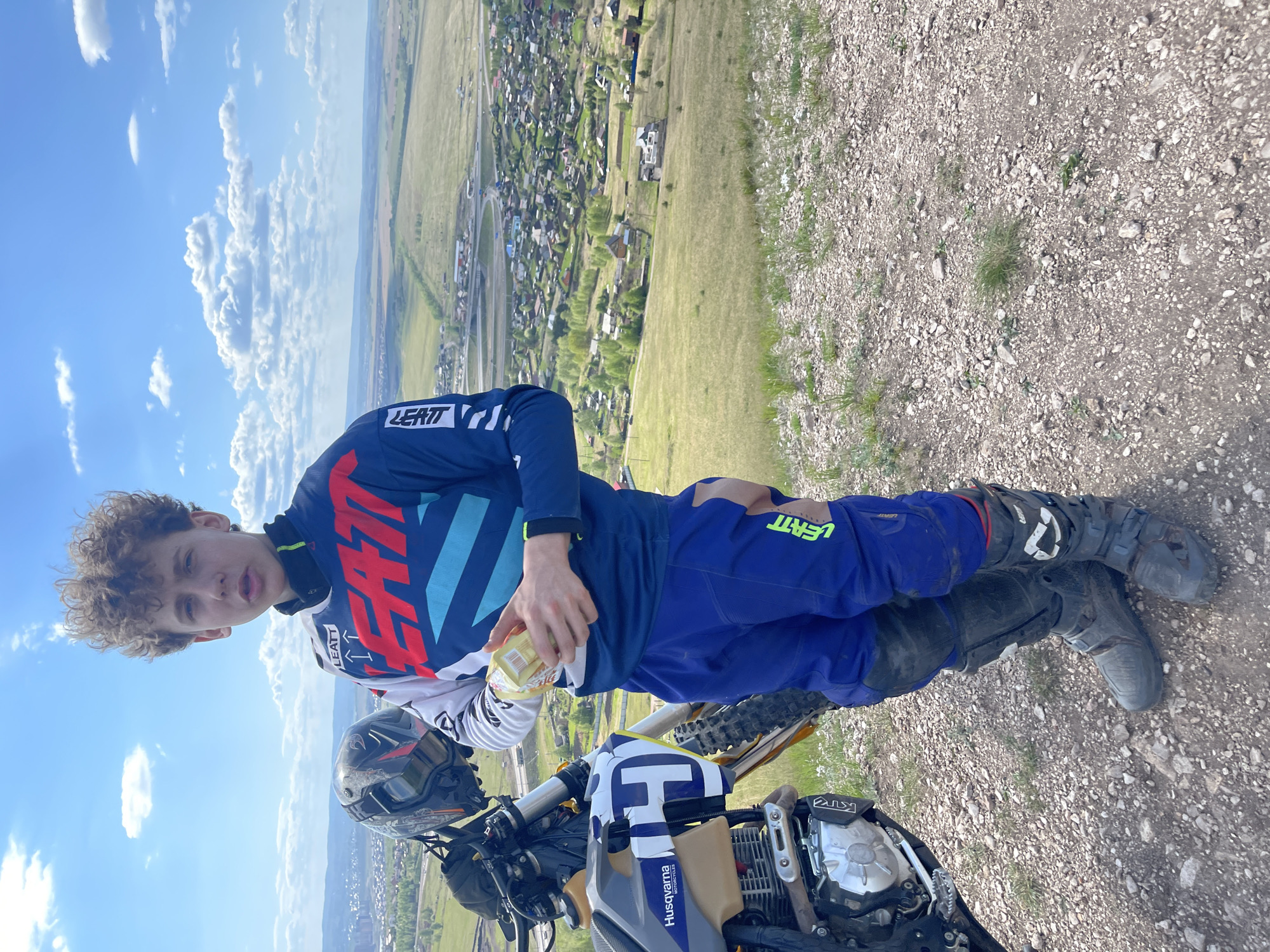 Teen dirt biker spotted on hillside overlooking Солонцы, Russia