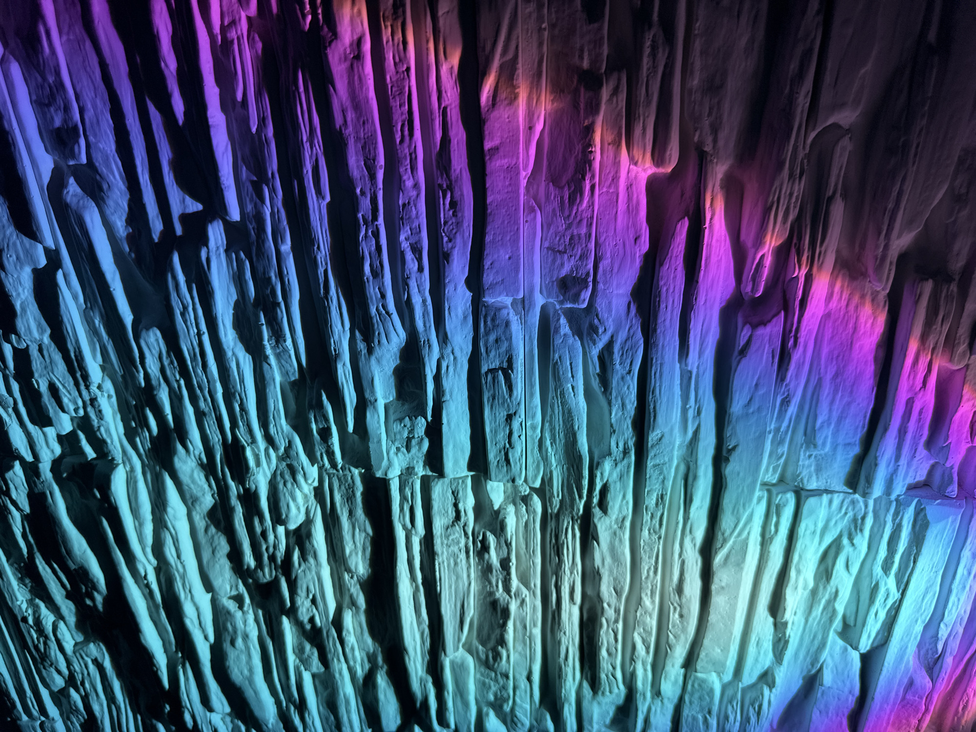 Textured surface illuminated by colored lights documented over five minutes