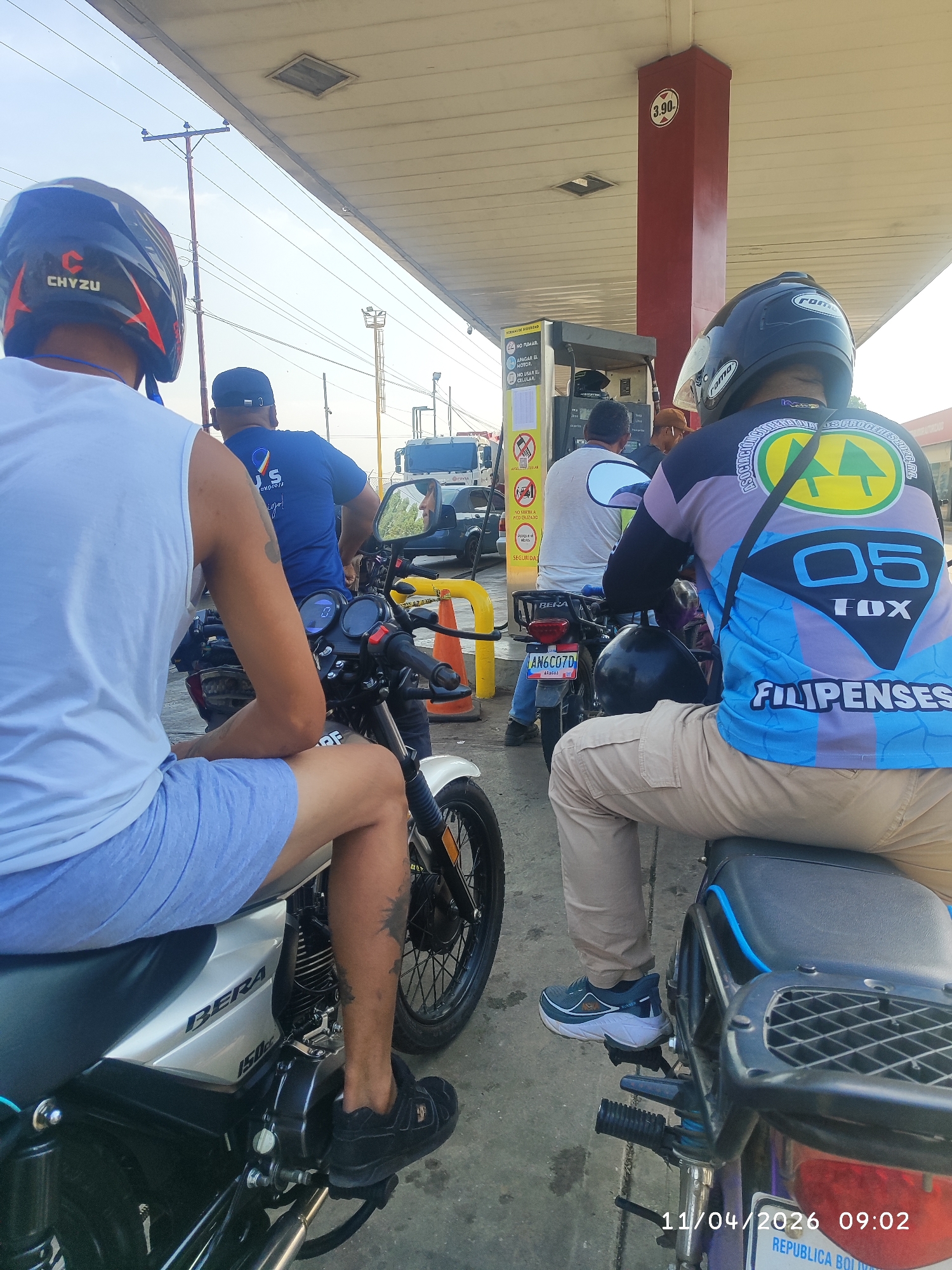 Motorcyclists queue for fuel at Venezuela gas station