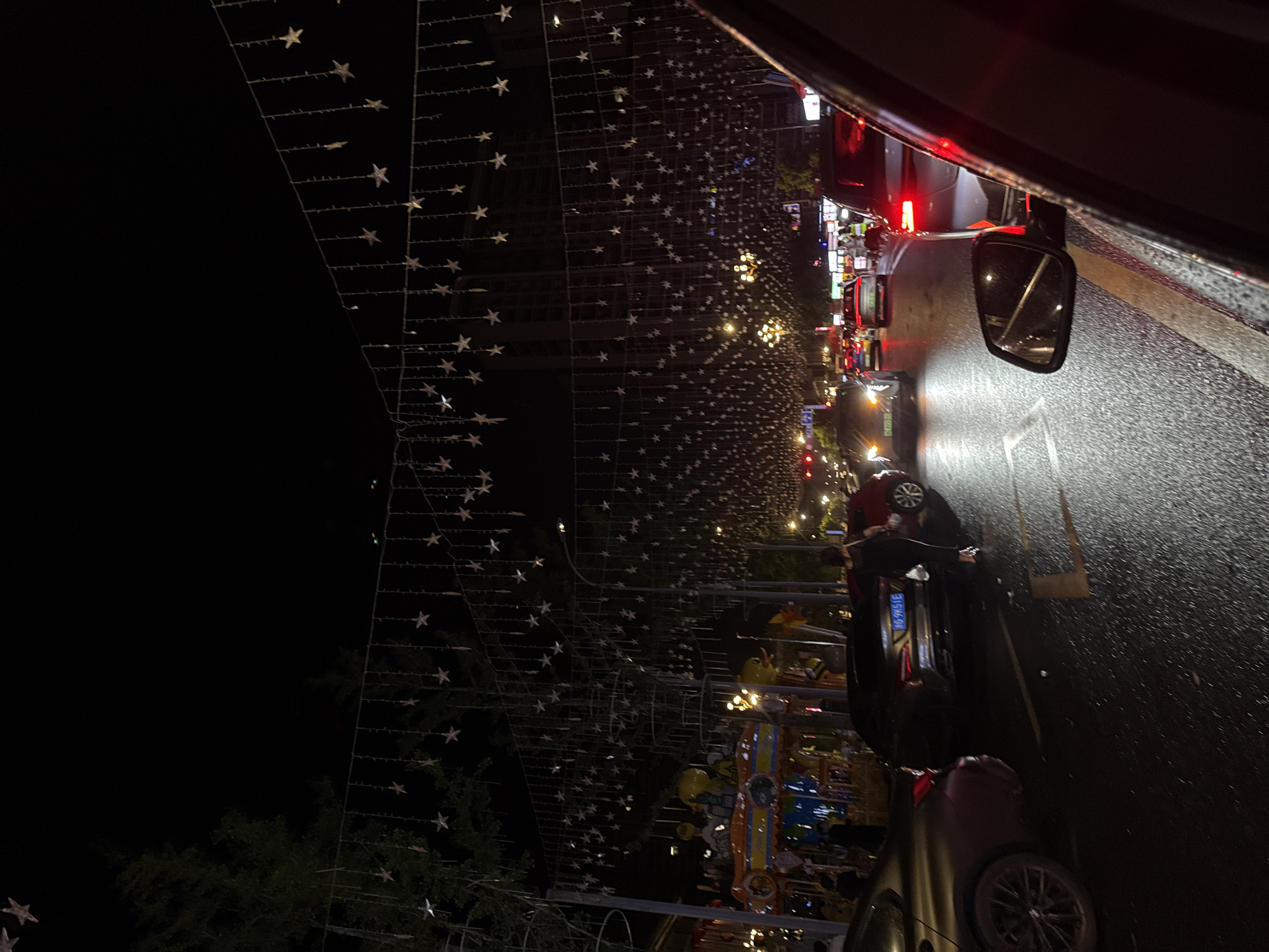 Yiwu street buzzes at night under star-shaped lights and a glowing carousel