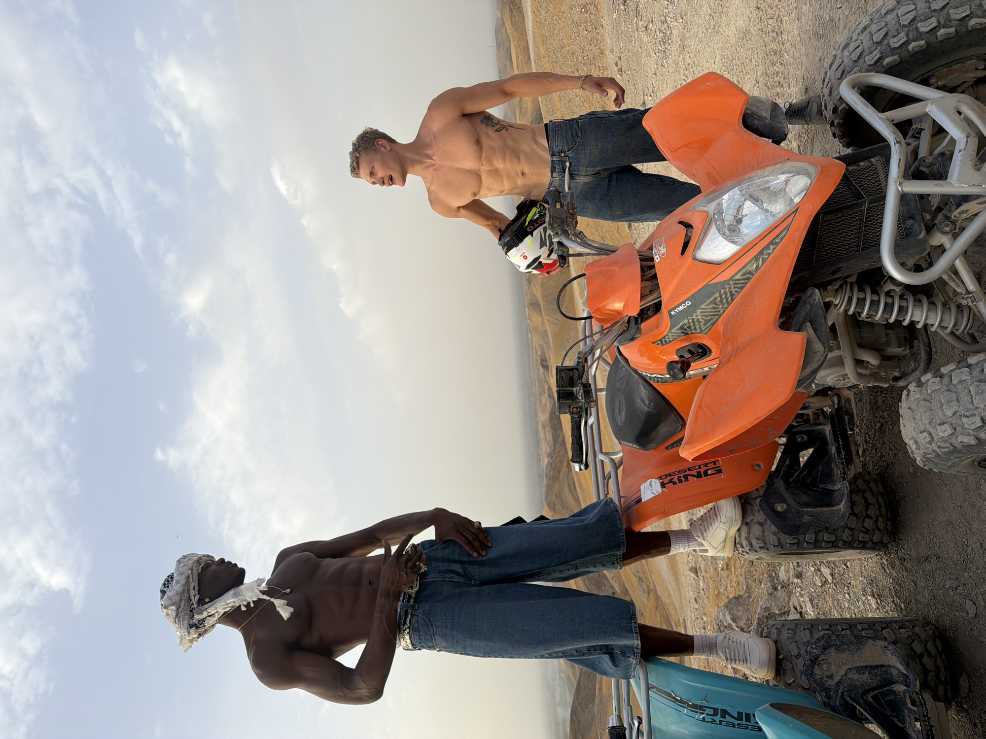 ATV riders hanging out on dusty Moroccan terrain