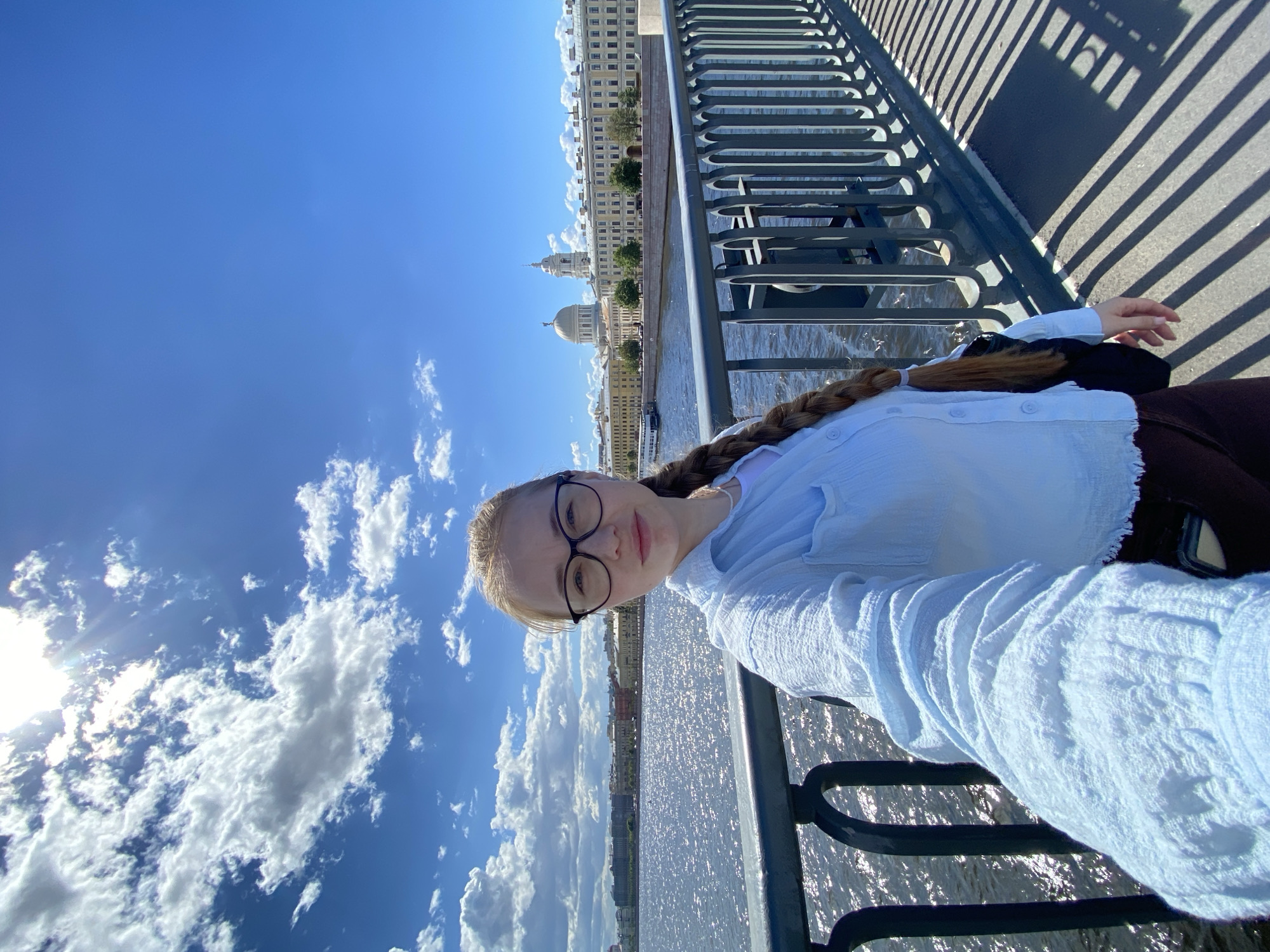 Sunny waterfront selfies with a glass skyscraper in the background