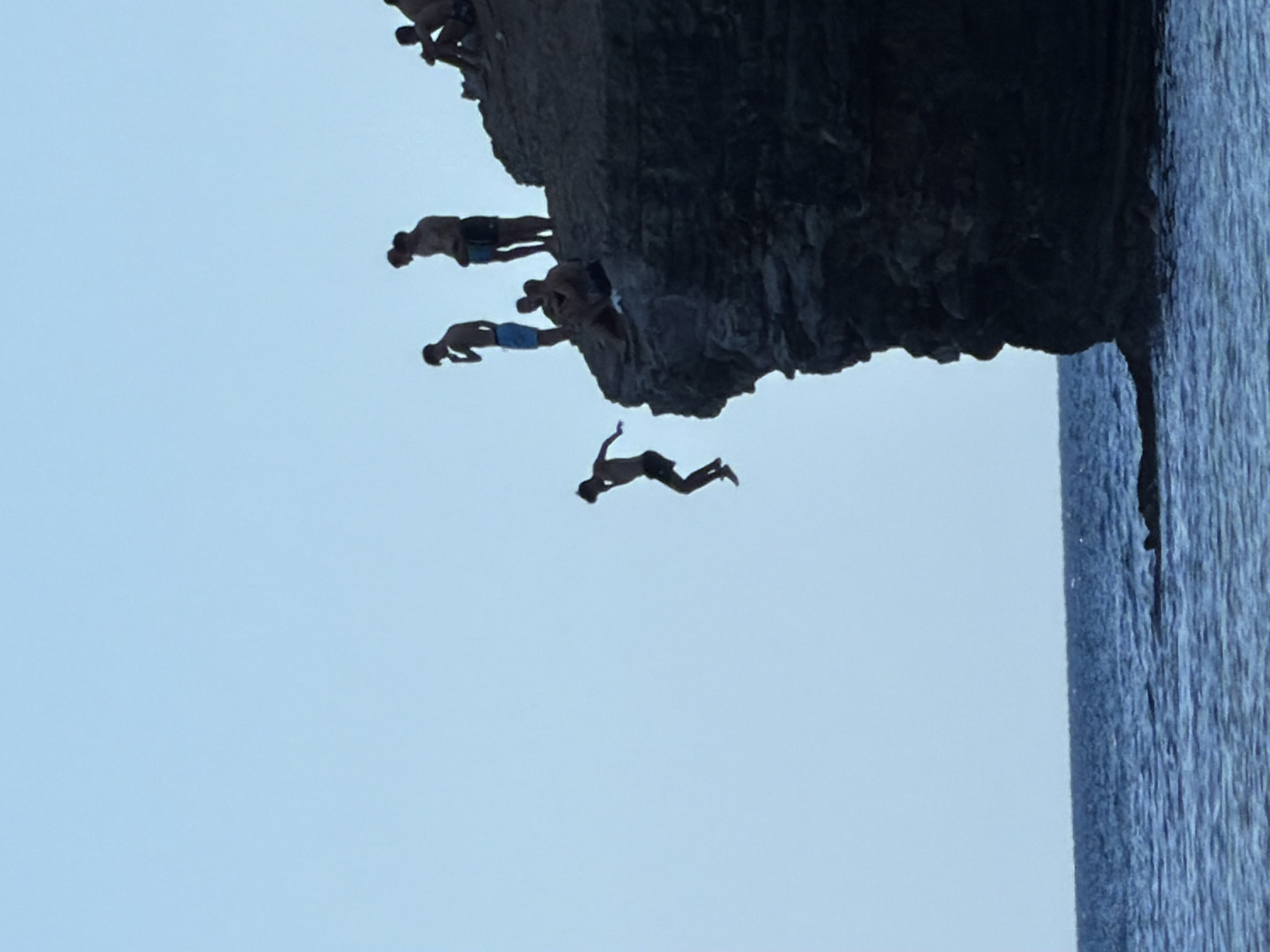 Cliff diving and beach scenes at a rocky Budva coastline