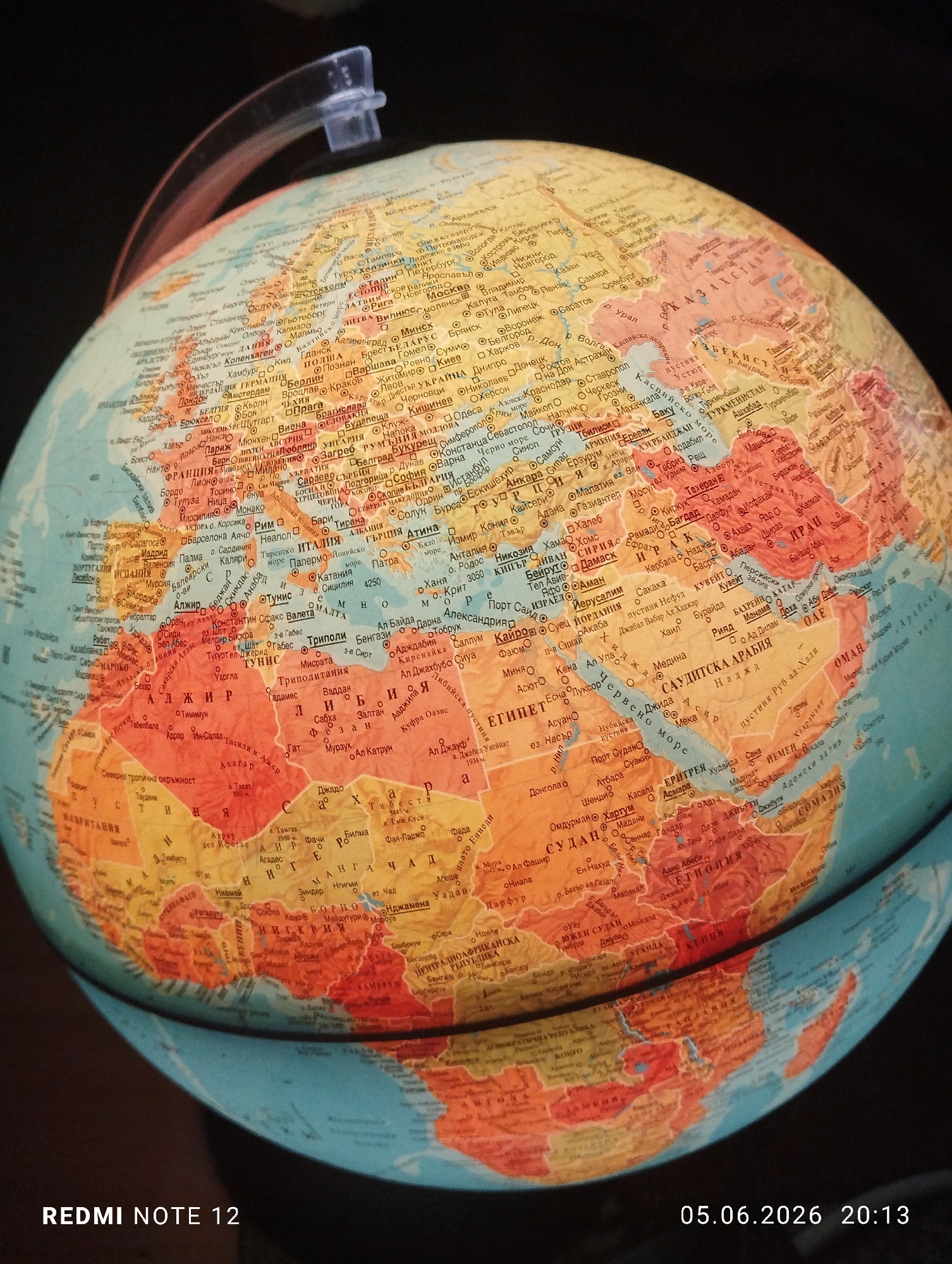 Close-up photograph captures colorful globe showing Europe, Africa, Asia