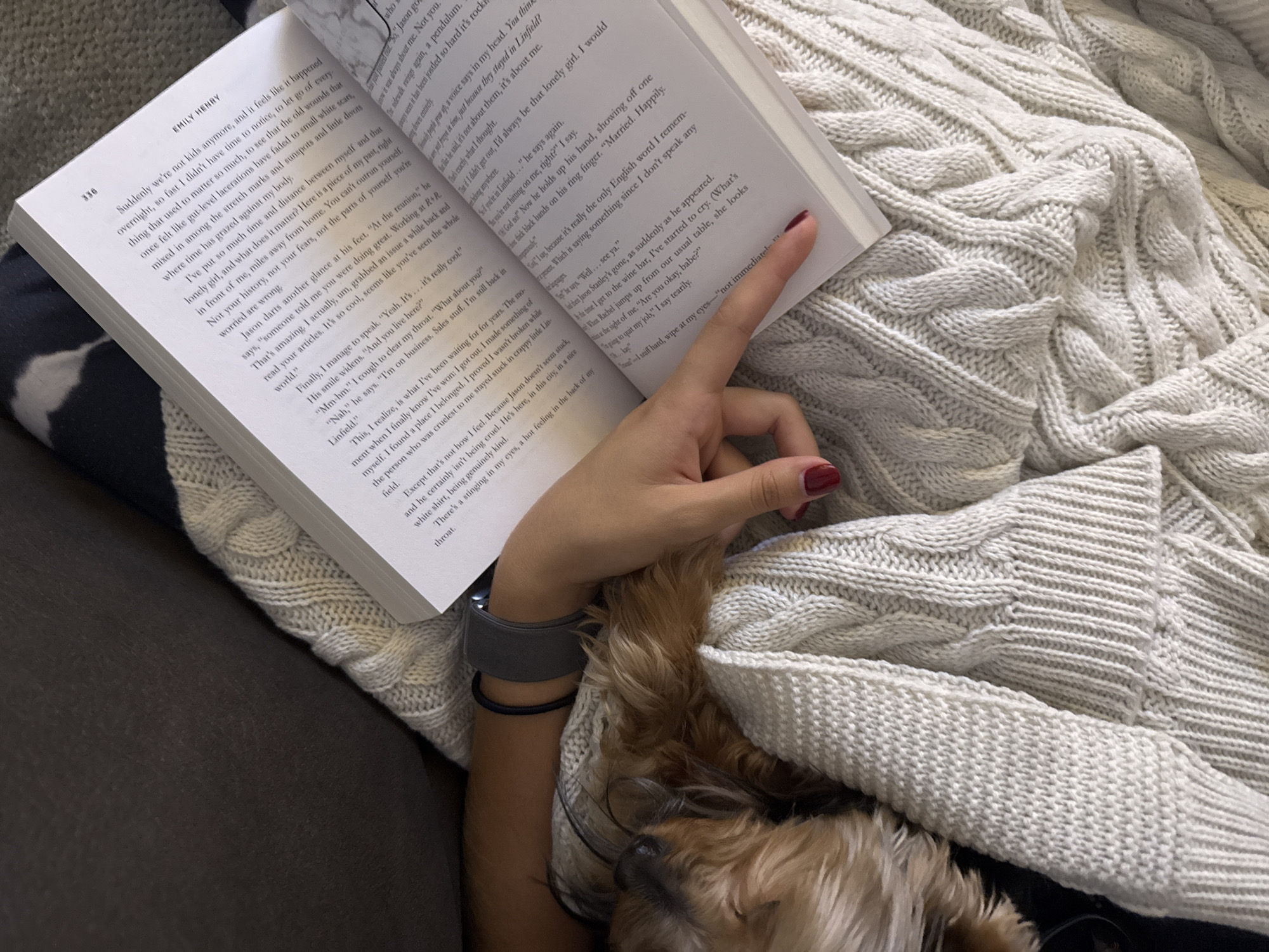 Reader enjoys quiet evening with book and dog companion