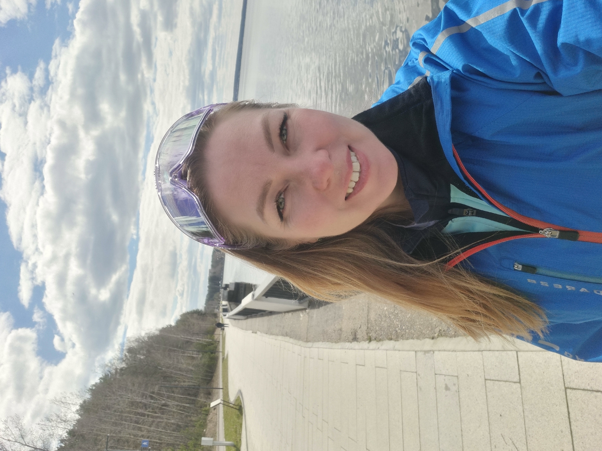 Woman photographs herself along Kama River embankment in Chaikovsky