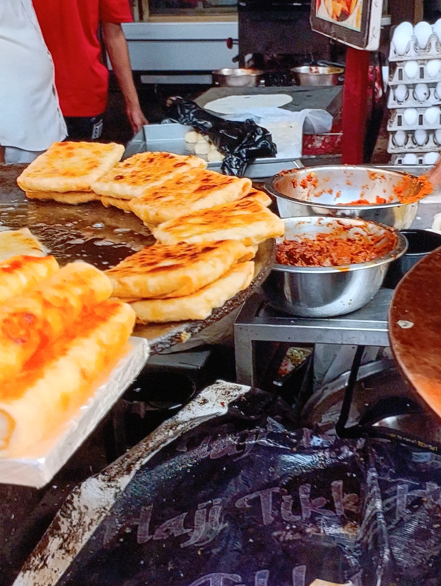 Street food vendor serves customers in busy urban area