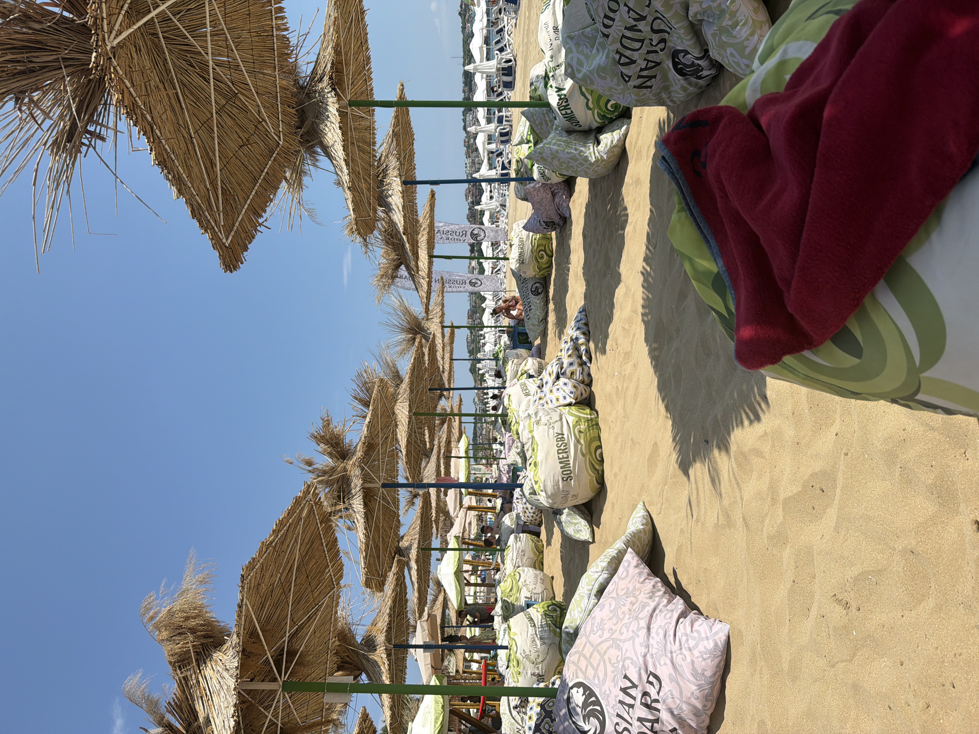 Sozopol beach packed out with beanbag seating on a sunny day