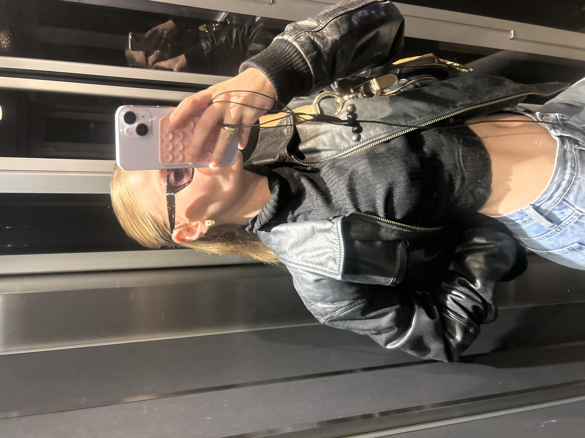 Person Takes Elevator Selfies in Black Leather Jacket