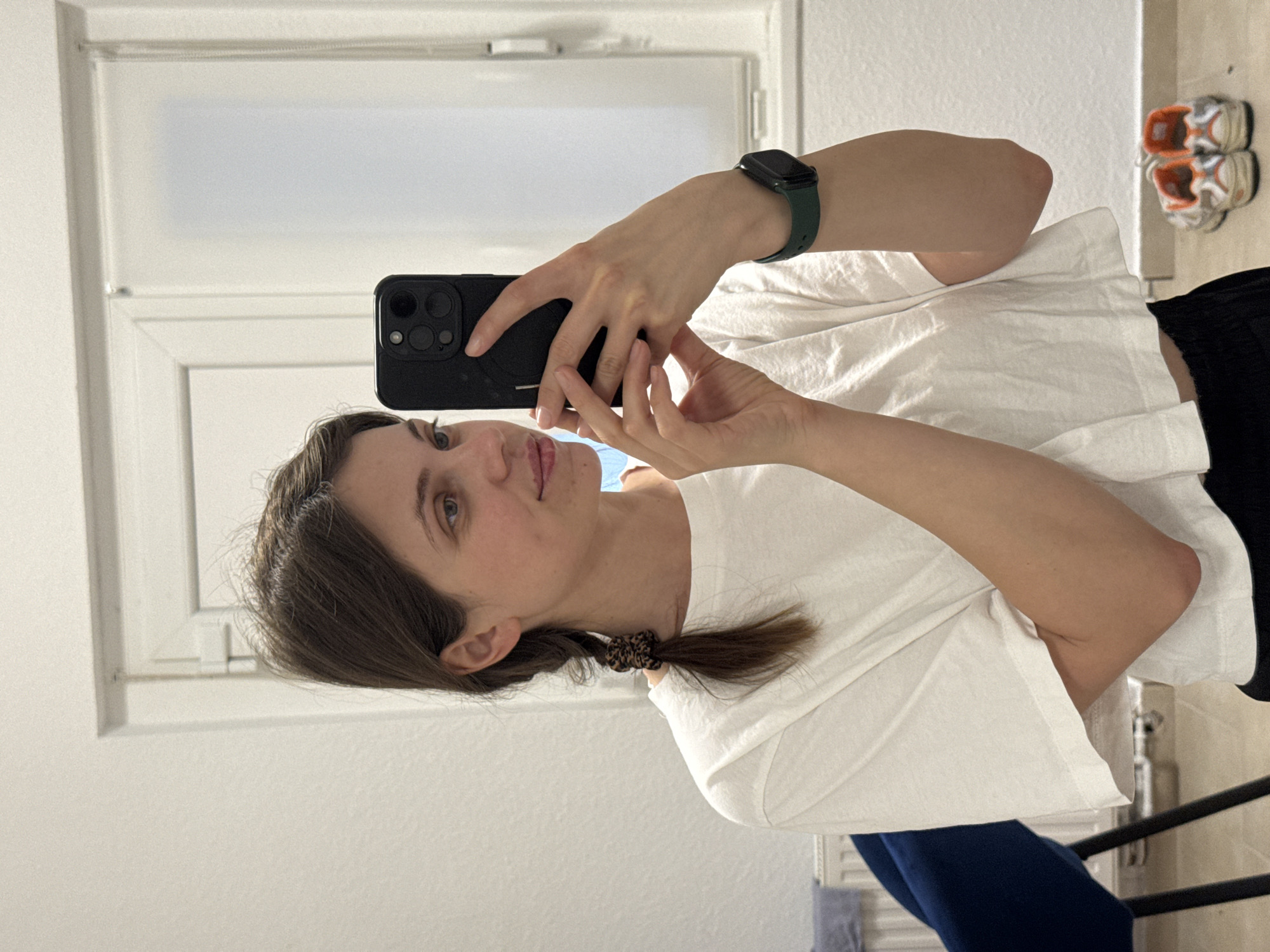 Woman takes bathroom mirror selfie in Kőröshegy, Hungary