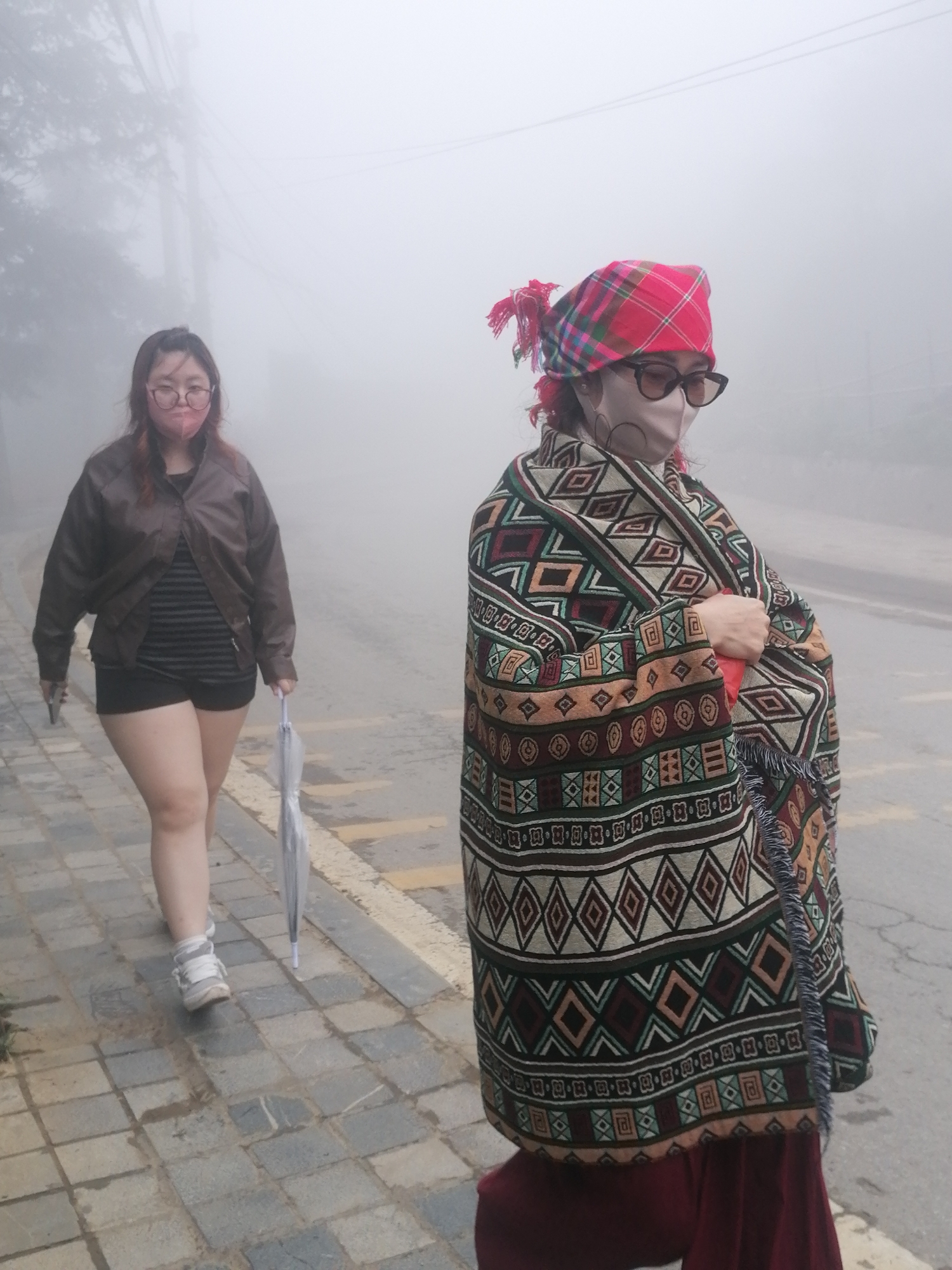 Two women spotted on foggy Sa Pa street