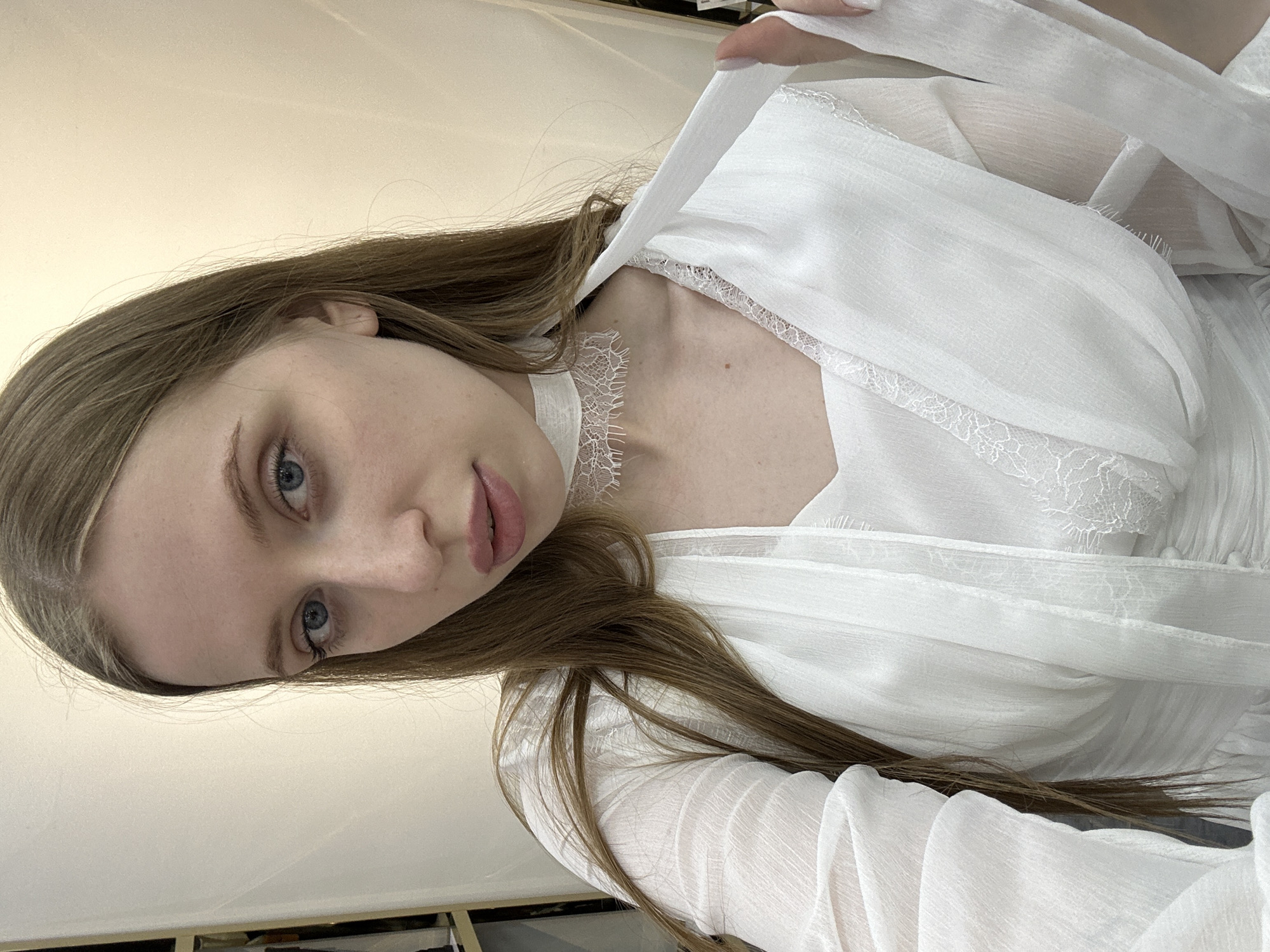 Woman takes selfie in clothing store dressing room