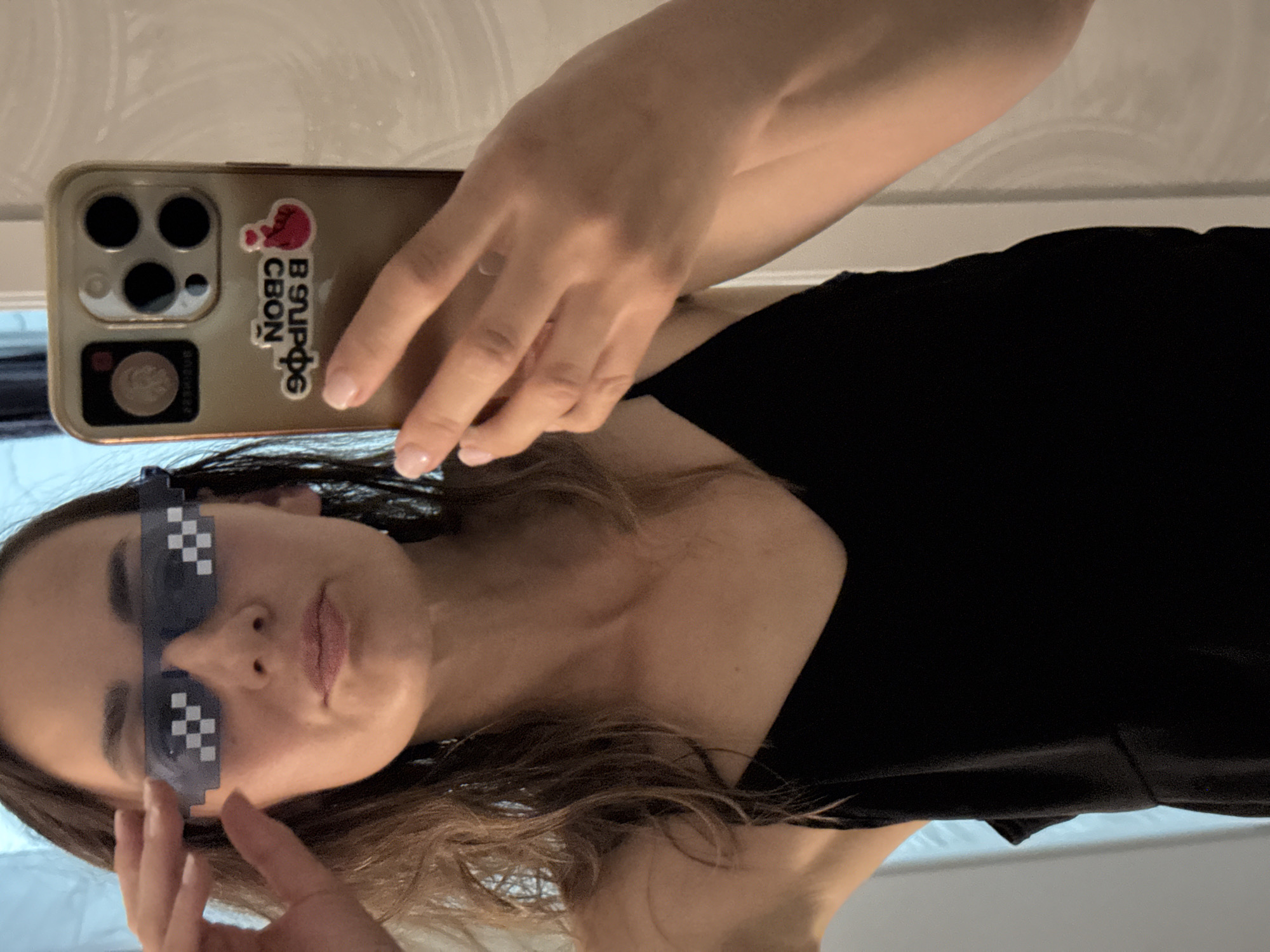 Mirror selfie in Sochi with pixelated shades and a gold phone