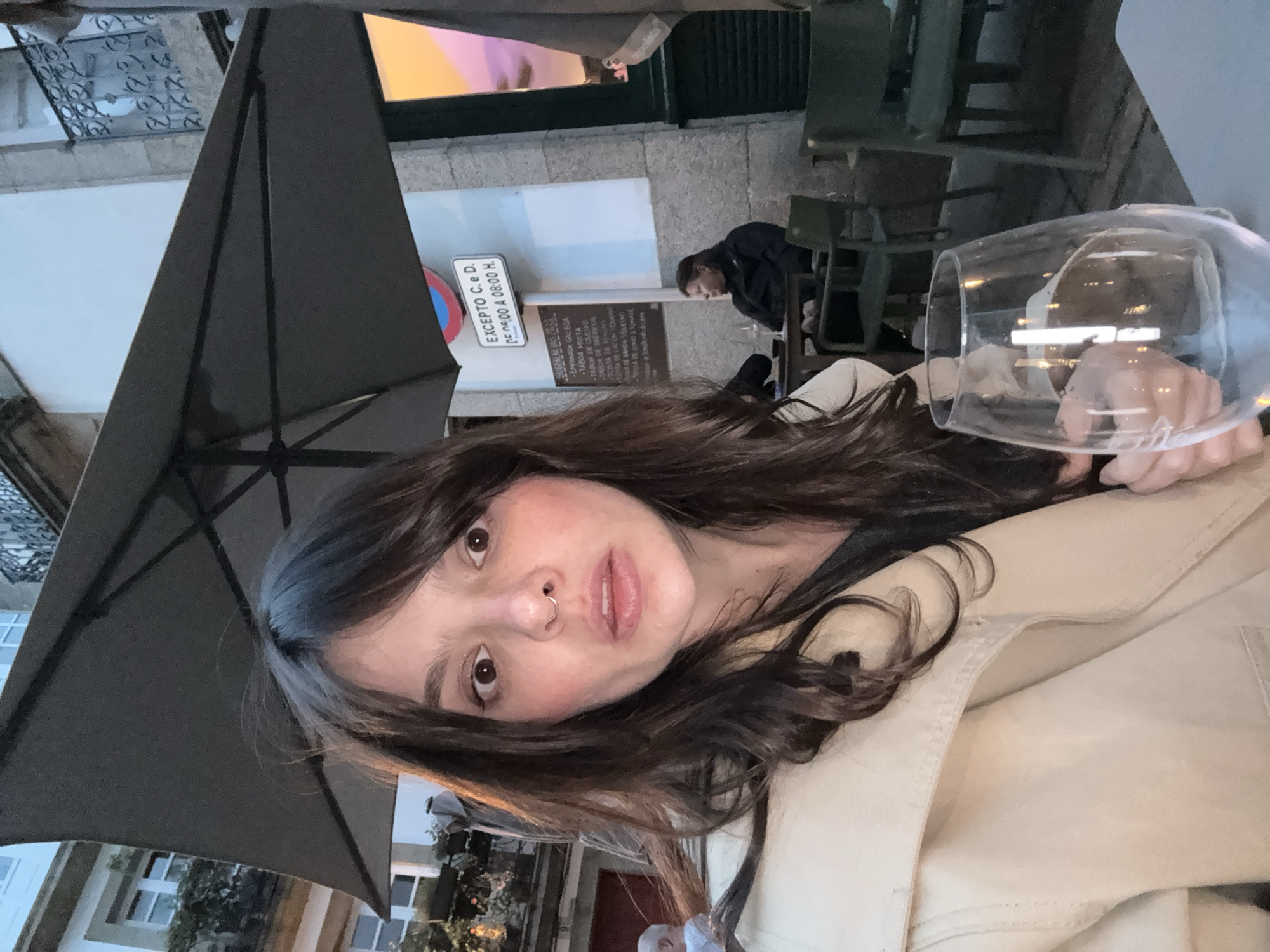 Woman takes selfie at Santiago cafe amid historic architecture