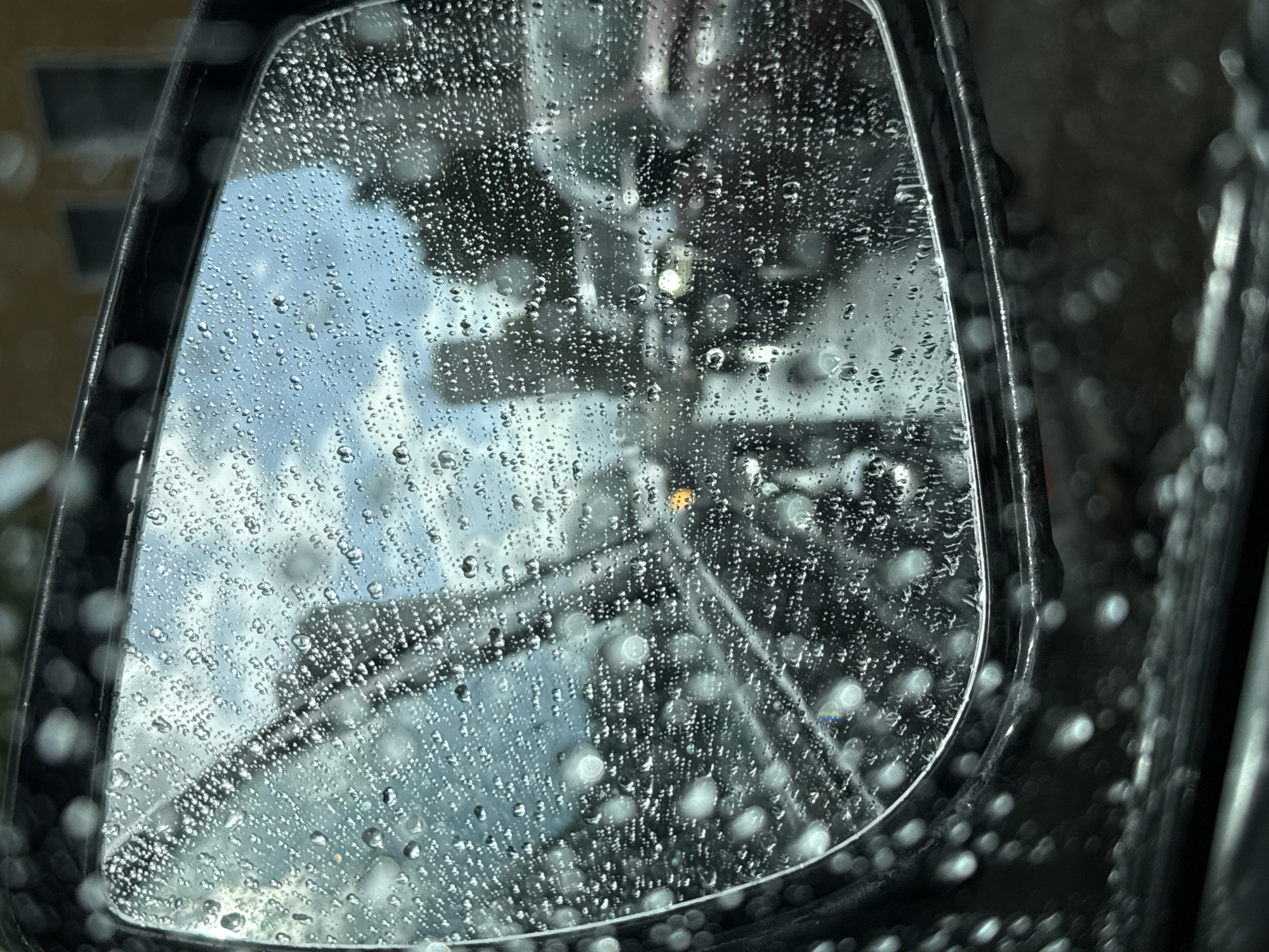 Driving through a rainy Kirov afternoon, streets slick and grey