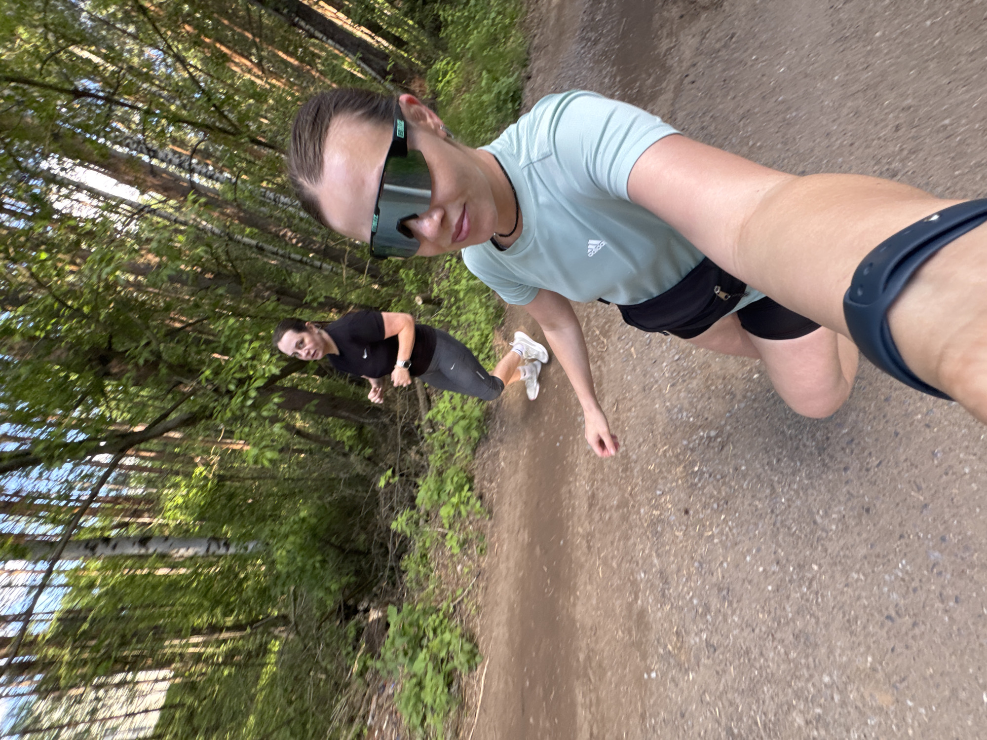 Women exercise on forest trail in Chaikovsky, Russia