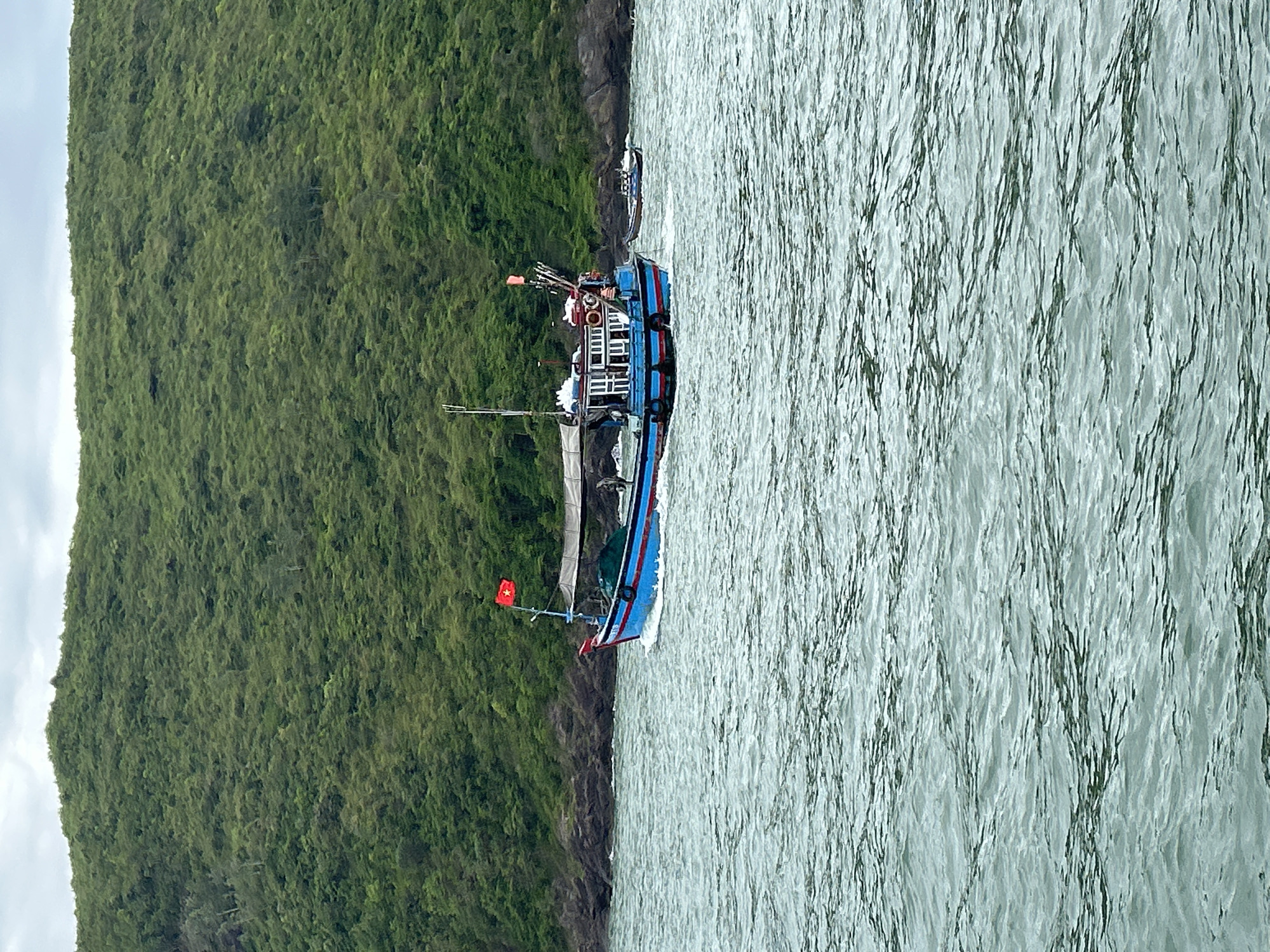 Fishing boats and tourist vessels share choppy Nha Trang coastal waters