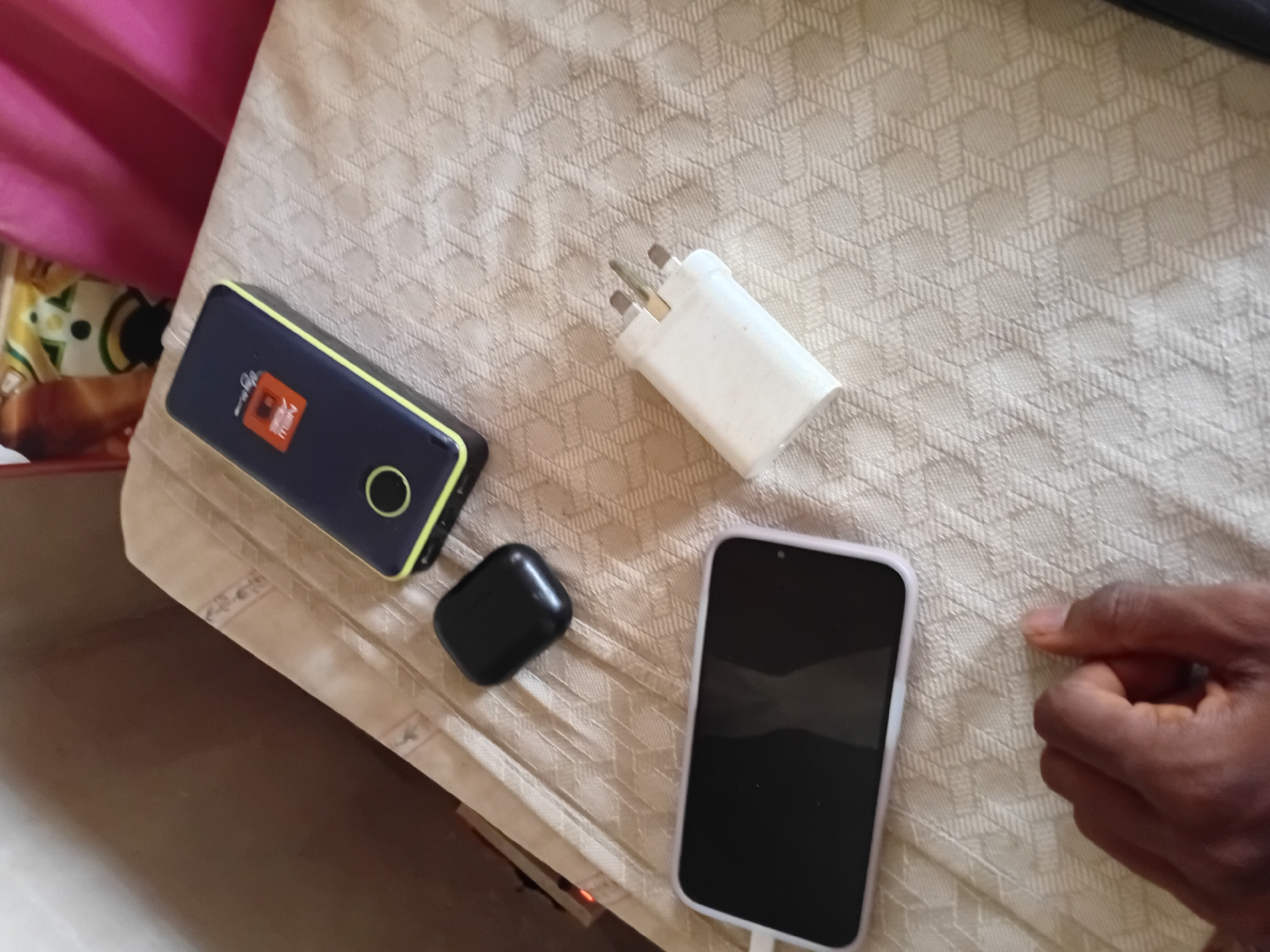 Personal electronics documented on textured surface in Minna