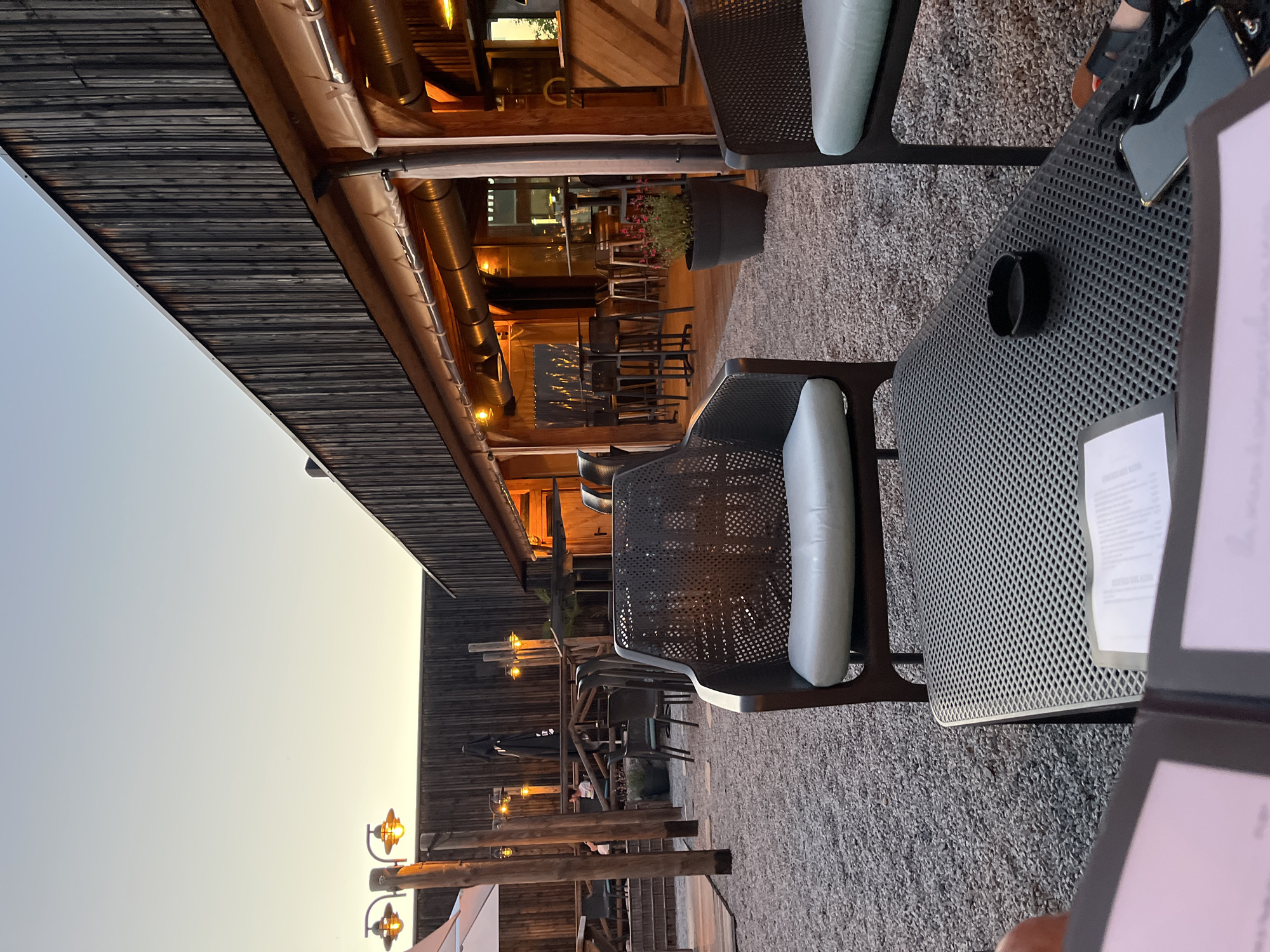 Evening diners gather at outdoor restaurant in Andrézieux-Bouthéon