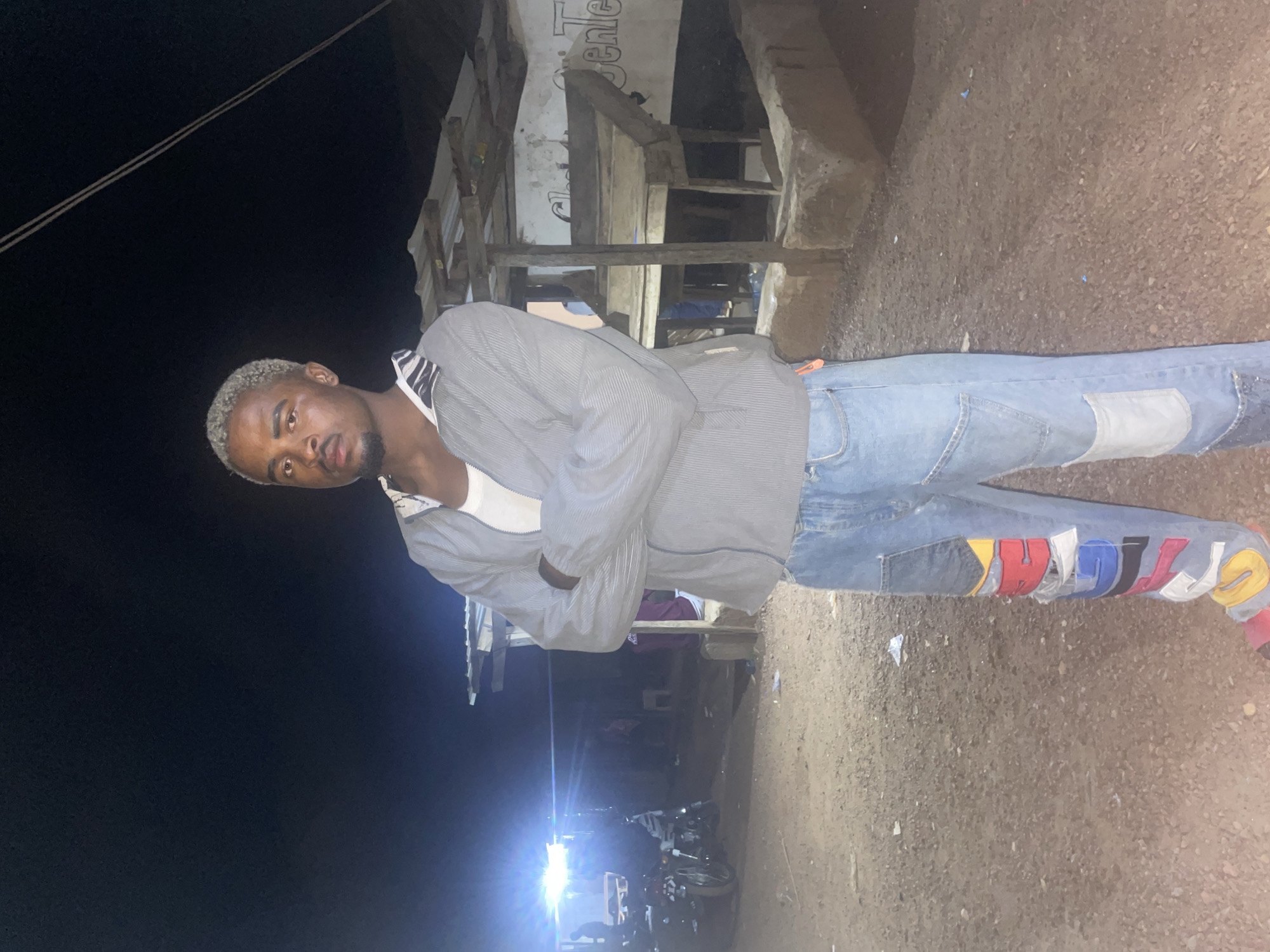 Man stands outside building at night in Durimi, Nigeria