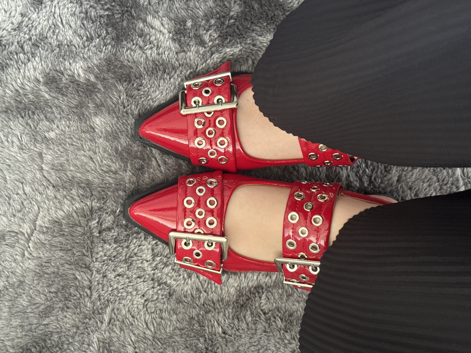 Person in red shoes poses for photos in Mexico City