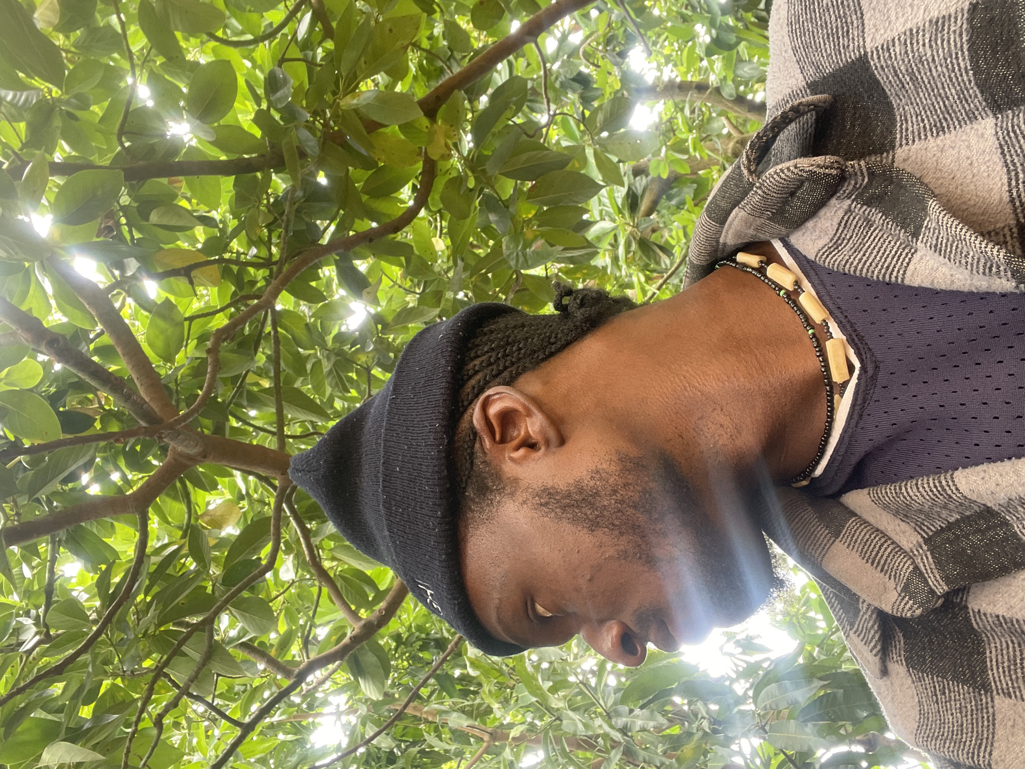 Portrait session beneath tree canopy captured in Jos, Nigeria