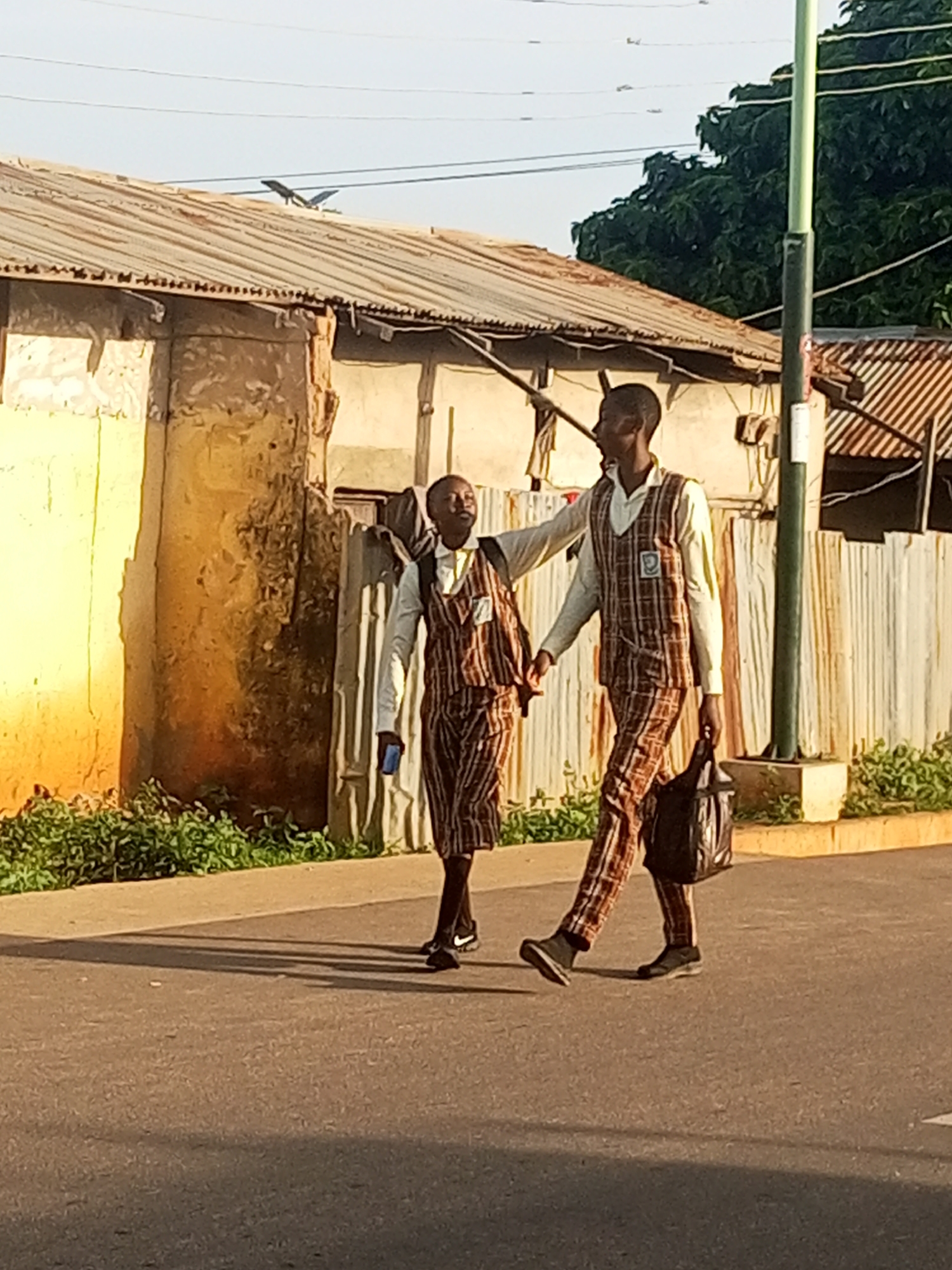 Morning street activity across two small Nigerian towns