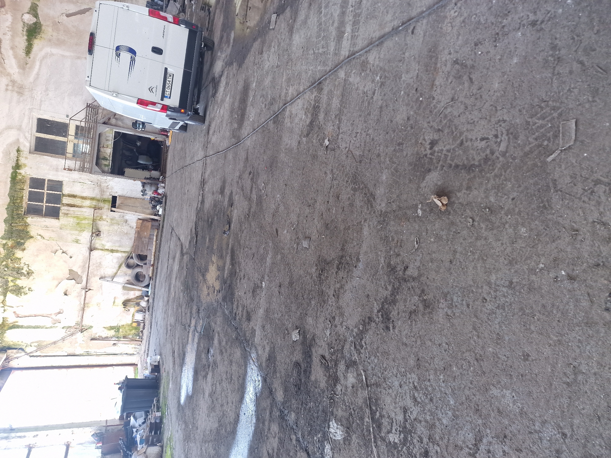 White van with Connecticut plates parked in concrete area