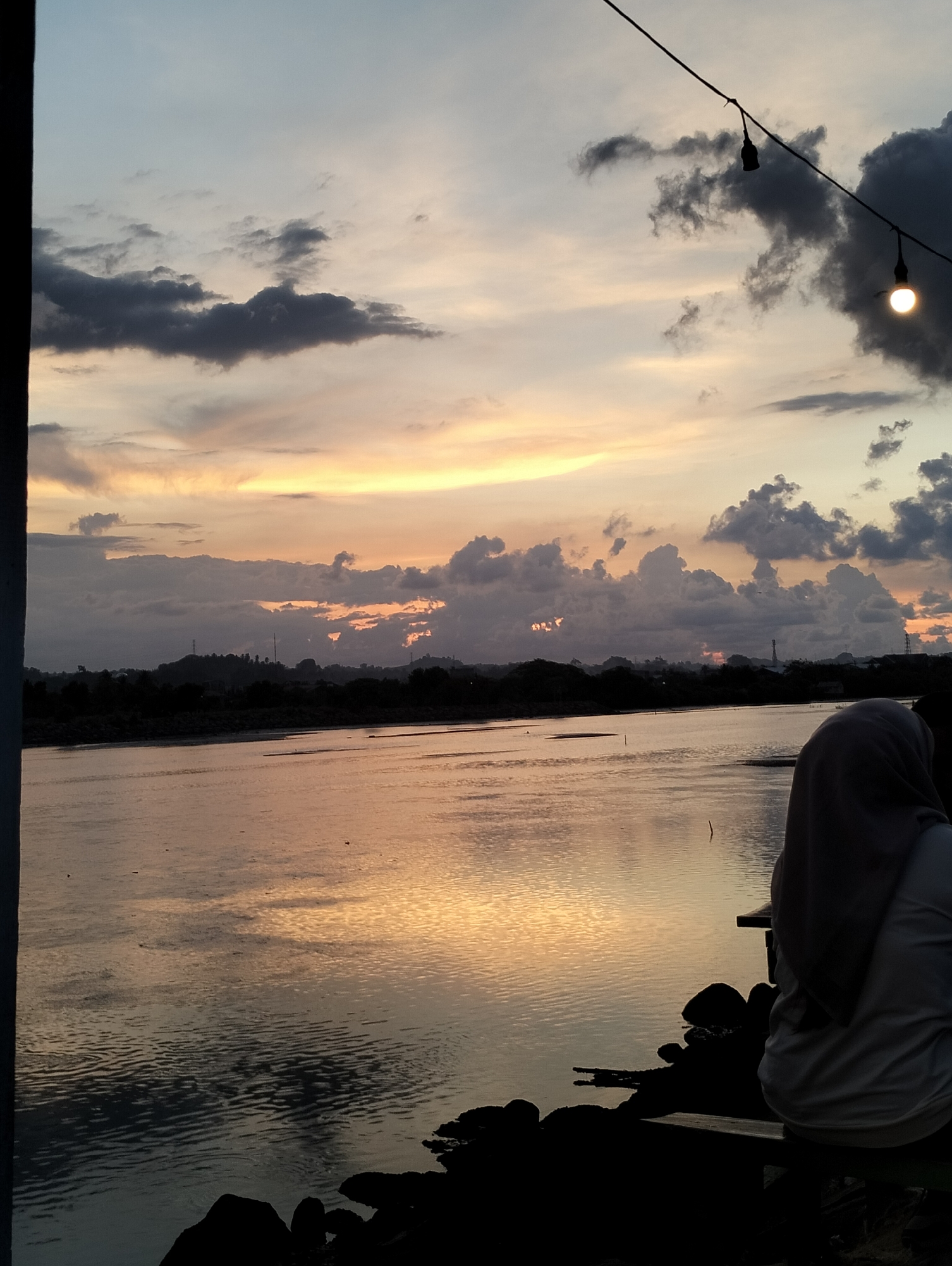 Evening waterfront leisure captured in Lhokseumawe, Indonesia