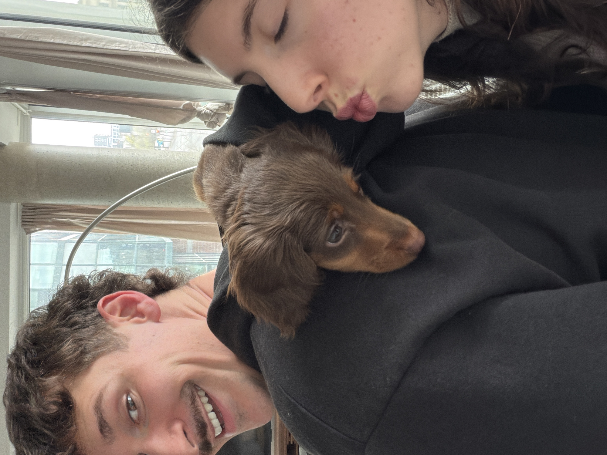 Couple takes selfies with dachshund puppy in Montreal apartment