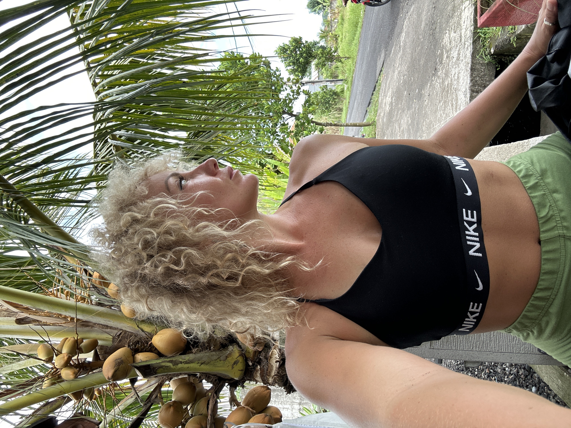 Woman in athletic wear spotted near palm tree