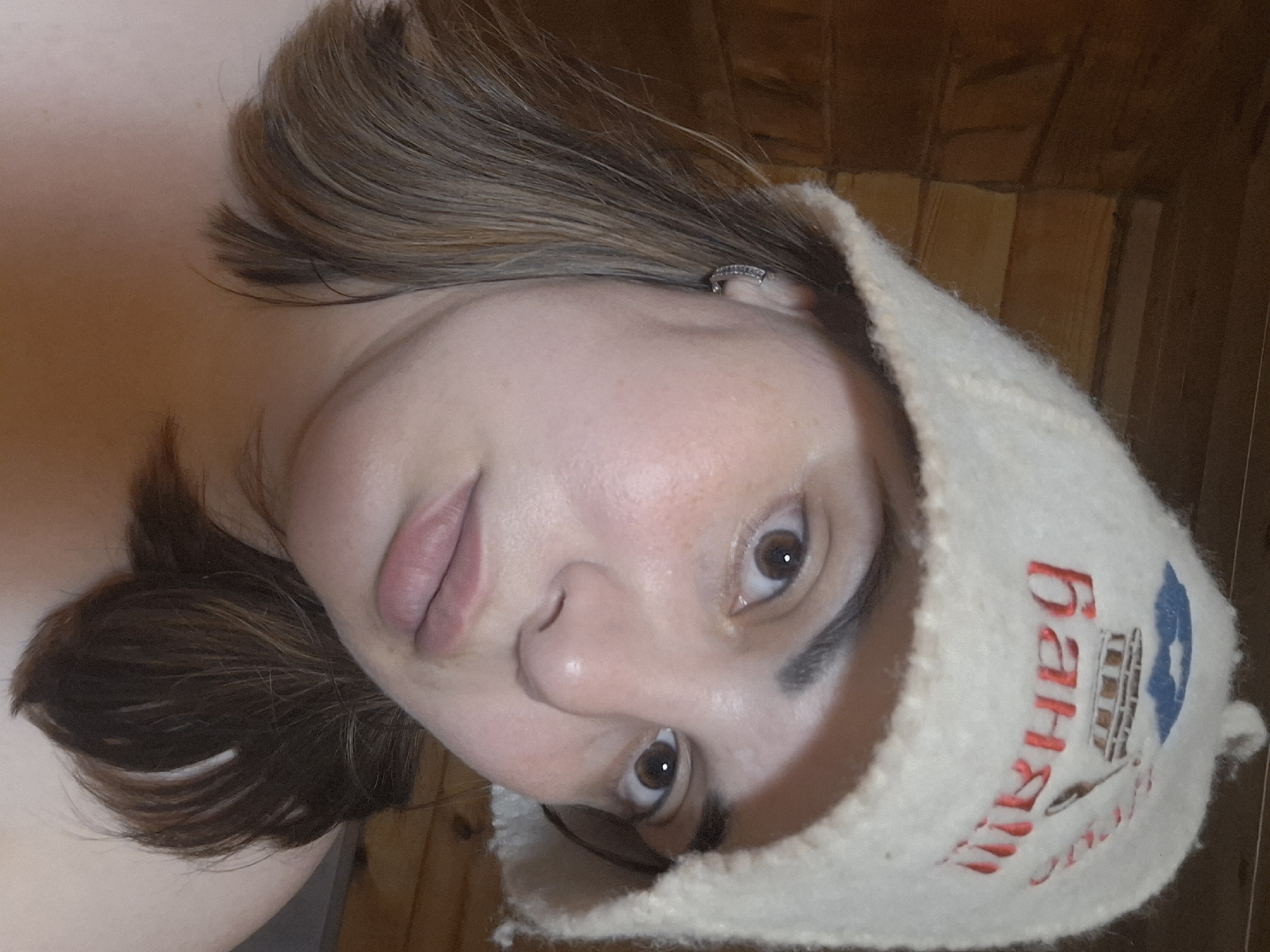 Woman in traditional sauna hat photographed at Russian banya