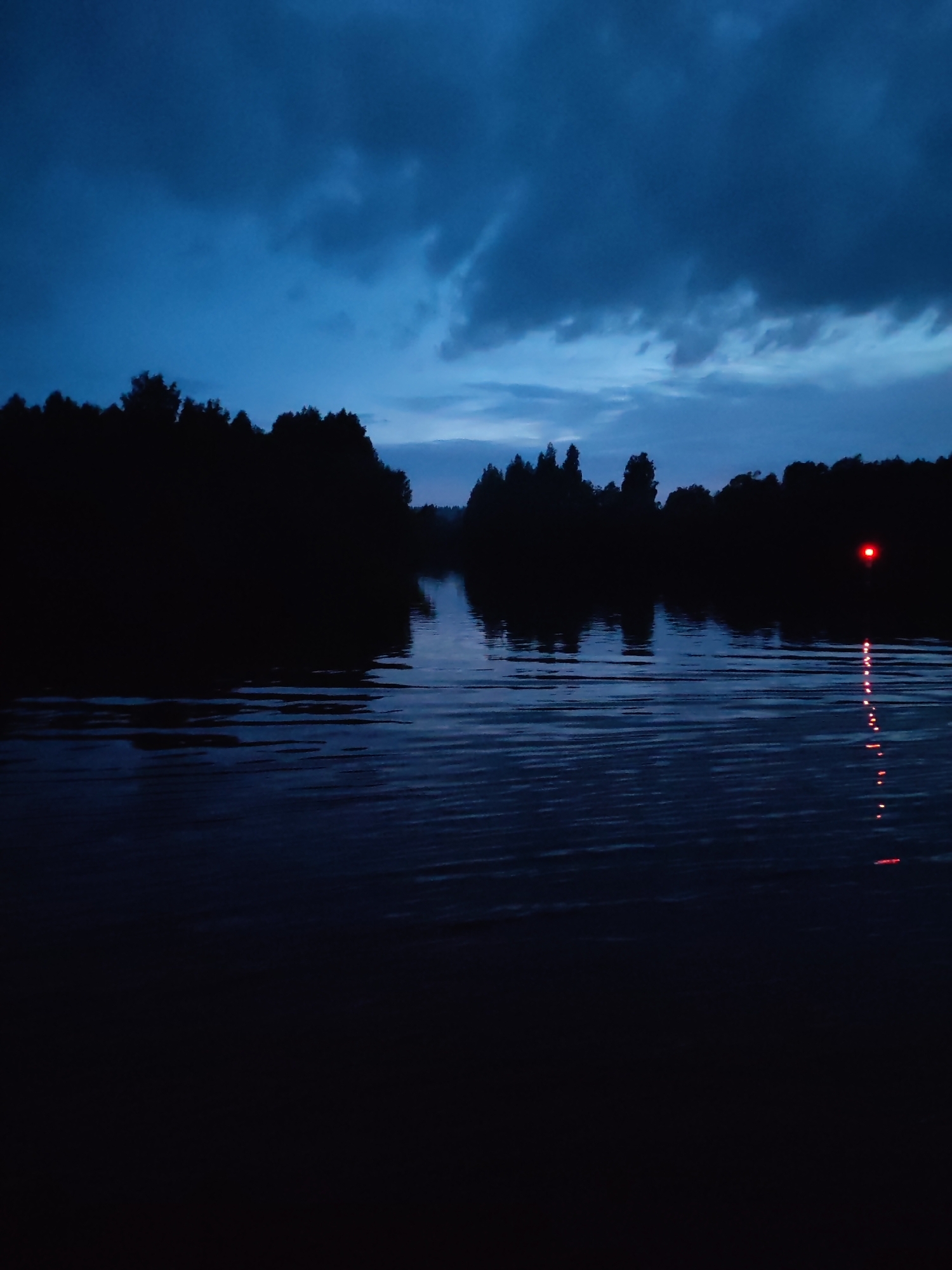 Dusk river transit through remote Russian waterway