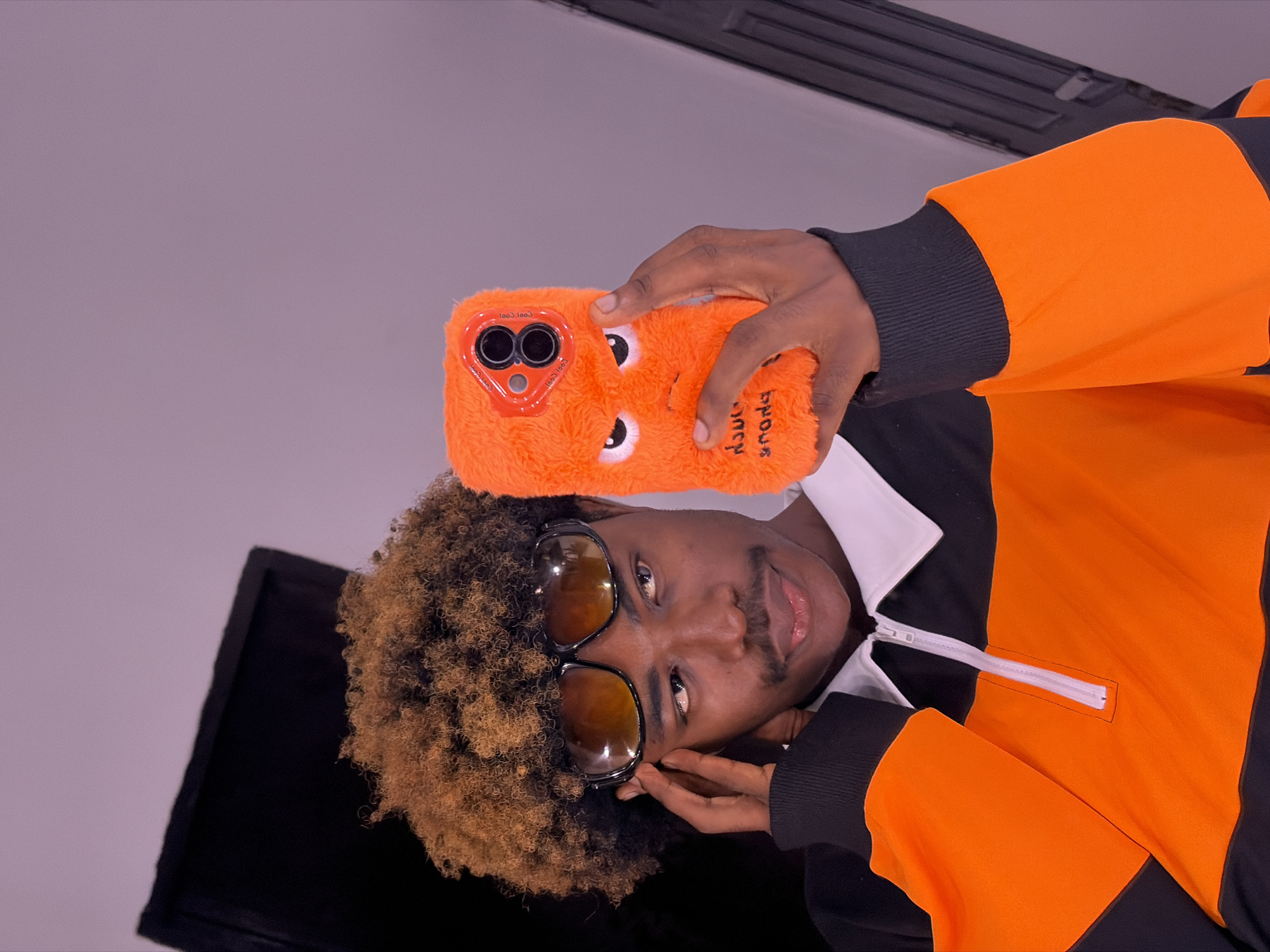 Man displays novelty phone case in Igboefon, Nigeria