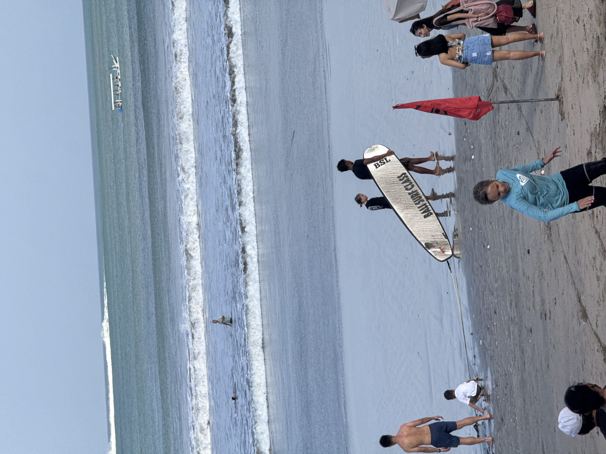 Surf session and beach life at Kuta on a clear morning