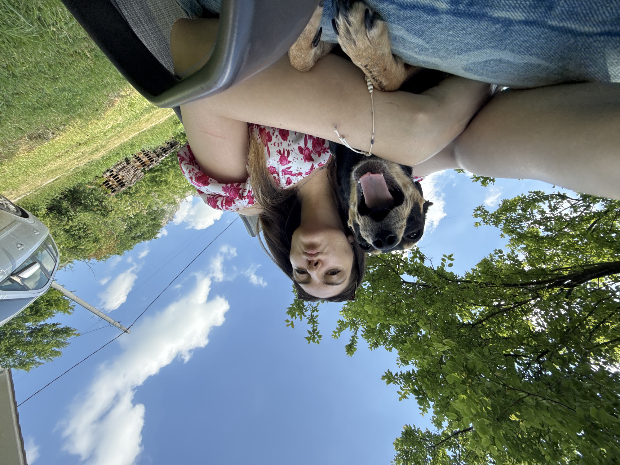 Woman relaxes with dog during outdoor afternoon in Bulgaria