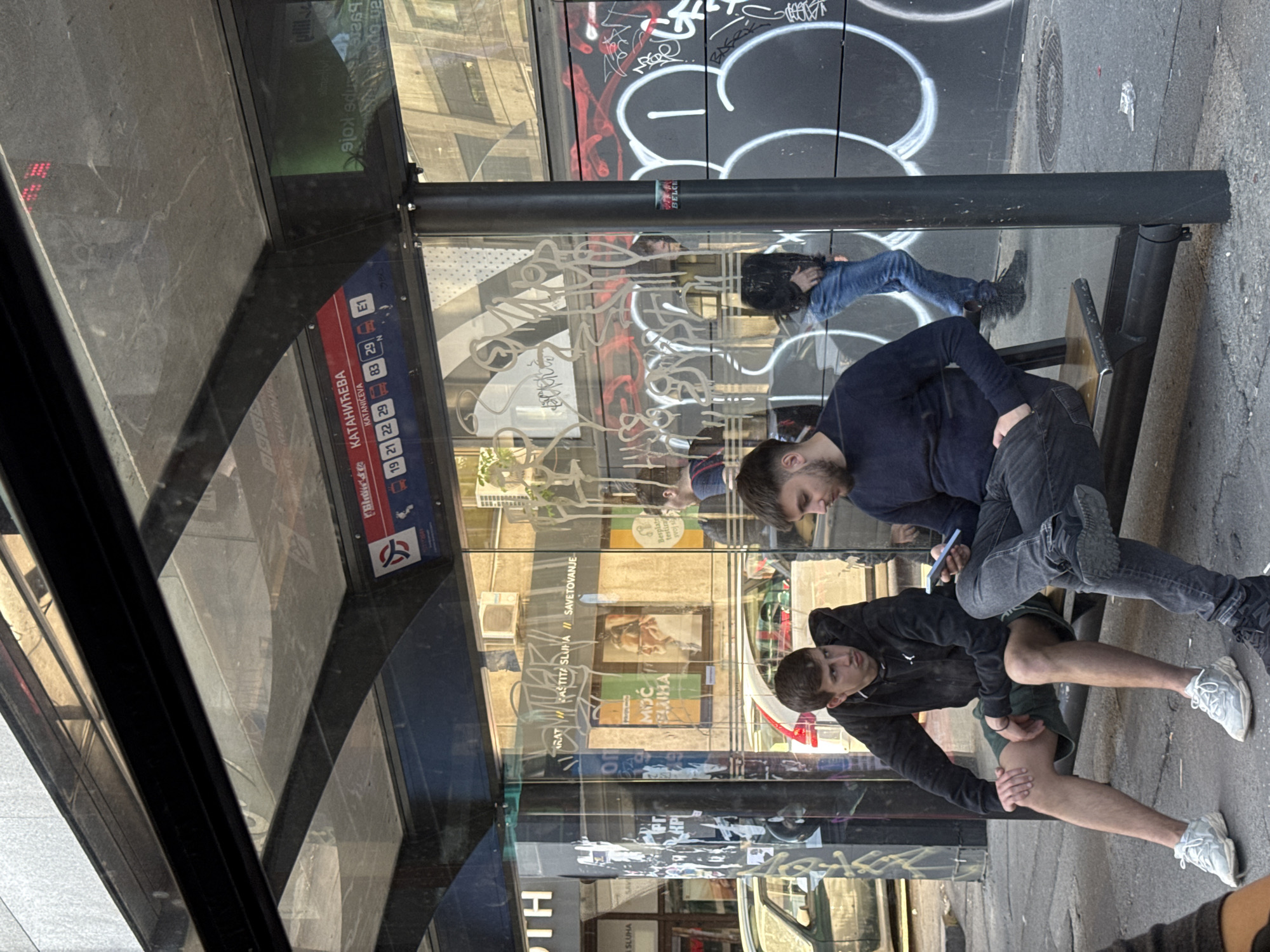 Graffiti-covered bus stop documented in Belgrade's Vracar district