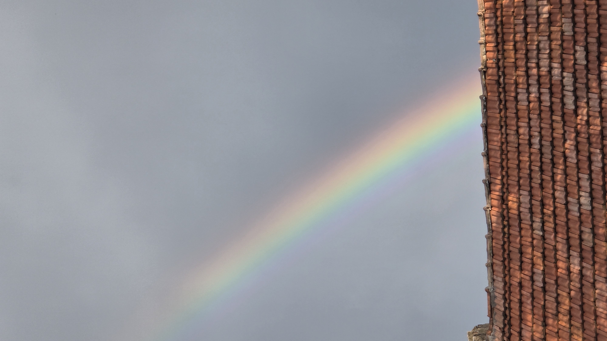 Rainbow arcs over residential Samovodene, Bulgaria