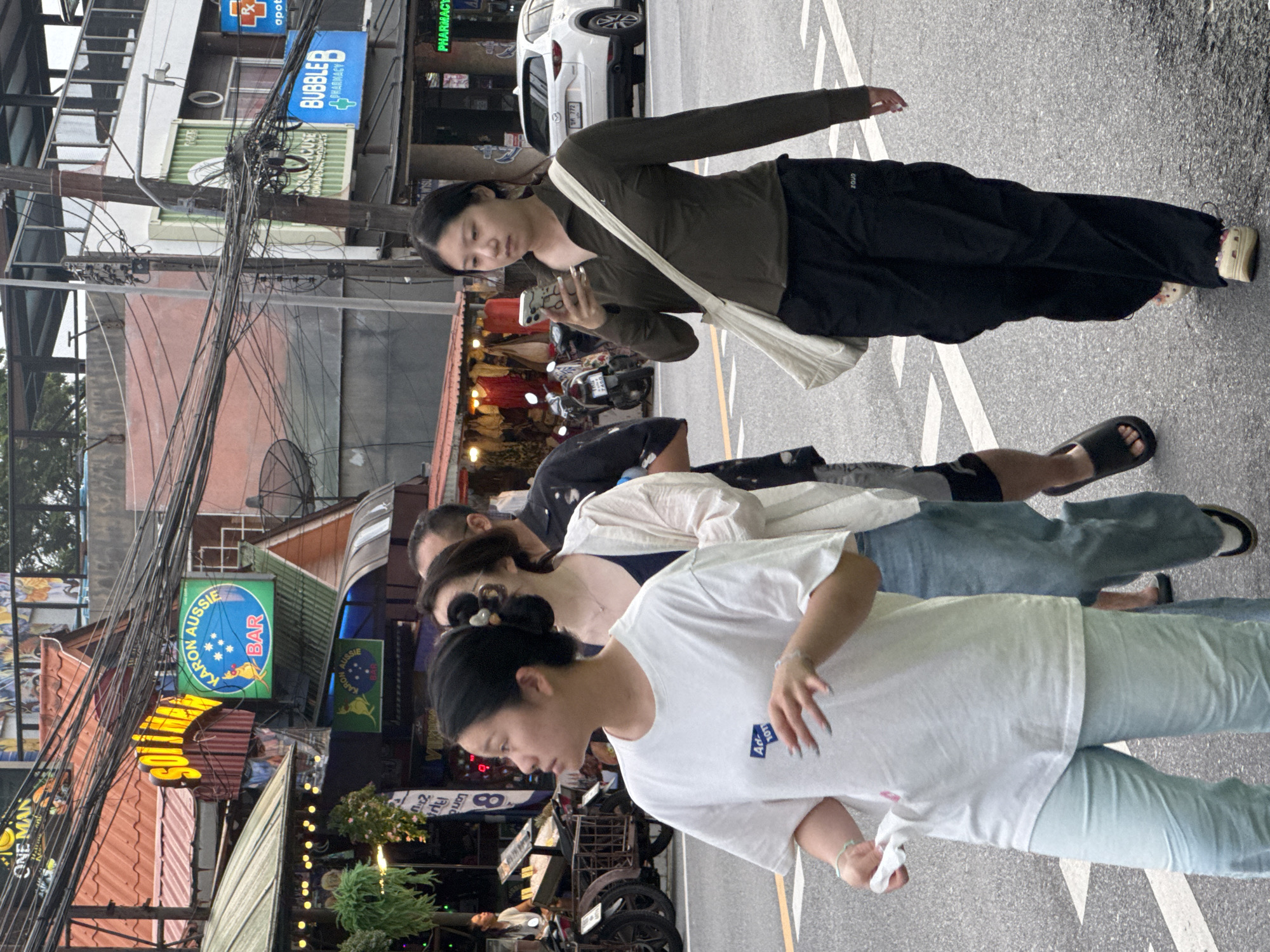Karon street scene: shops, traffic, and foot traffic on a grey afternoon