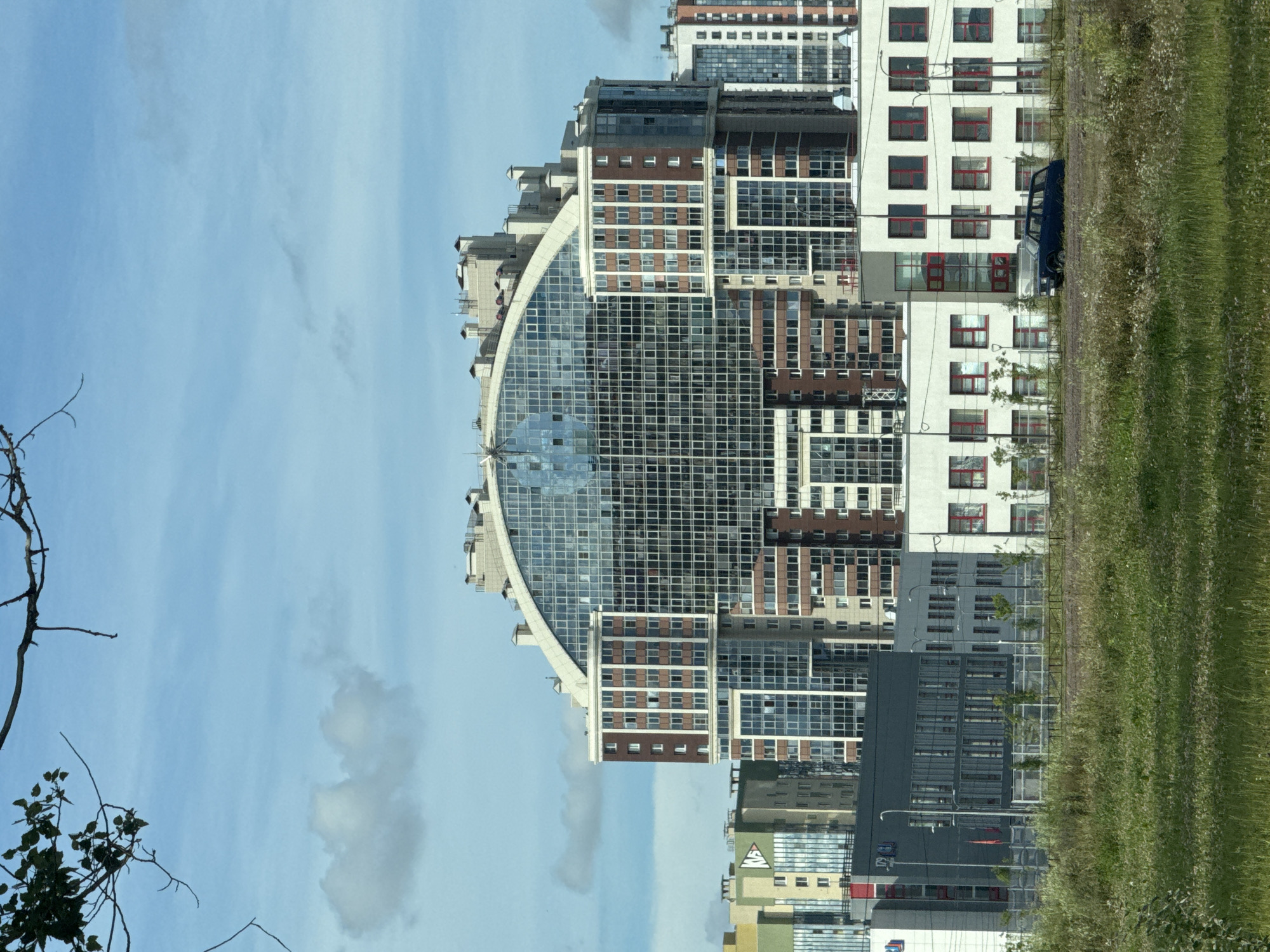 Curved glass residential tower in a new Saint Petersburg development