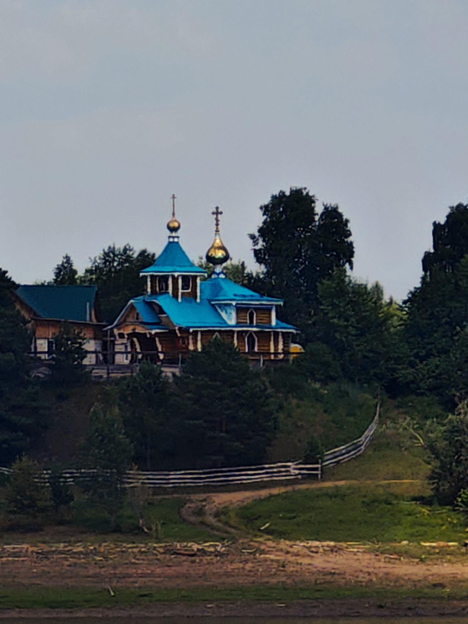 Wooden Orthodox church and river life in rural Siberia