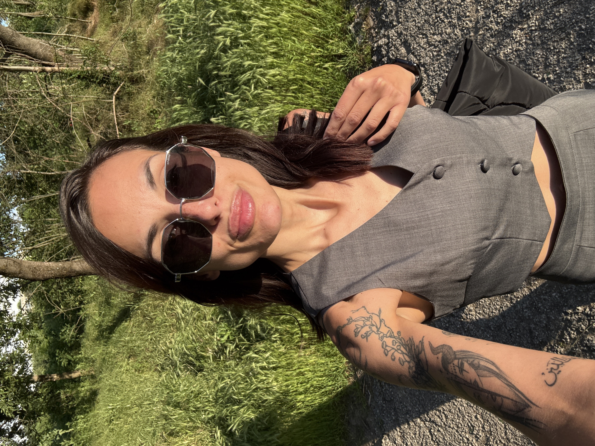 Tattooed woman in gray vest spotted outdoors, elevator in Pleven