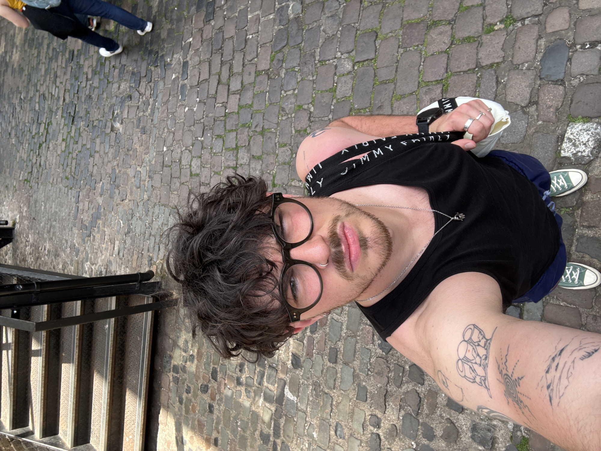 People gather, take photos on cobblestone street
